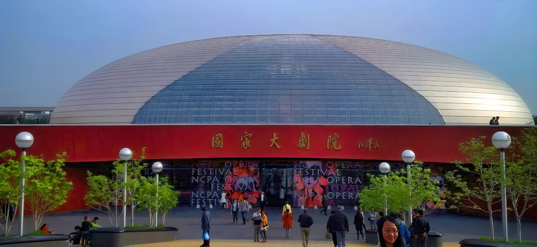 Modern domed building with red trim and glass facade.