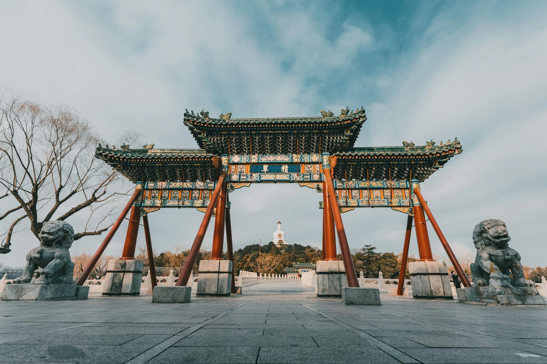 Explore the majestic archway and stone lions in historic Beihai Park, Beijing.