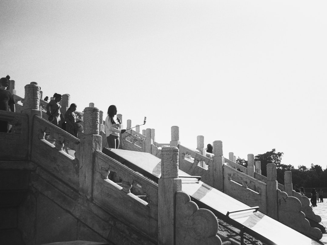 A black and white photo of a skateboarder doing a trick