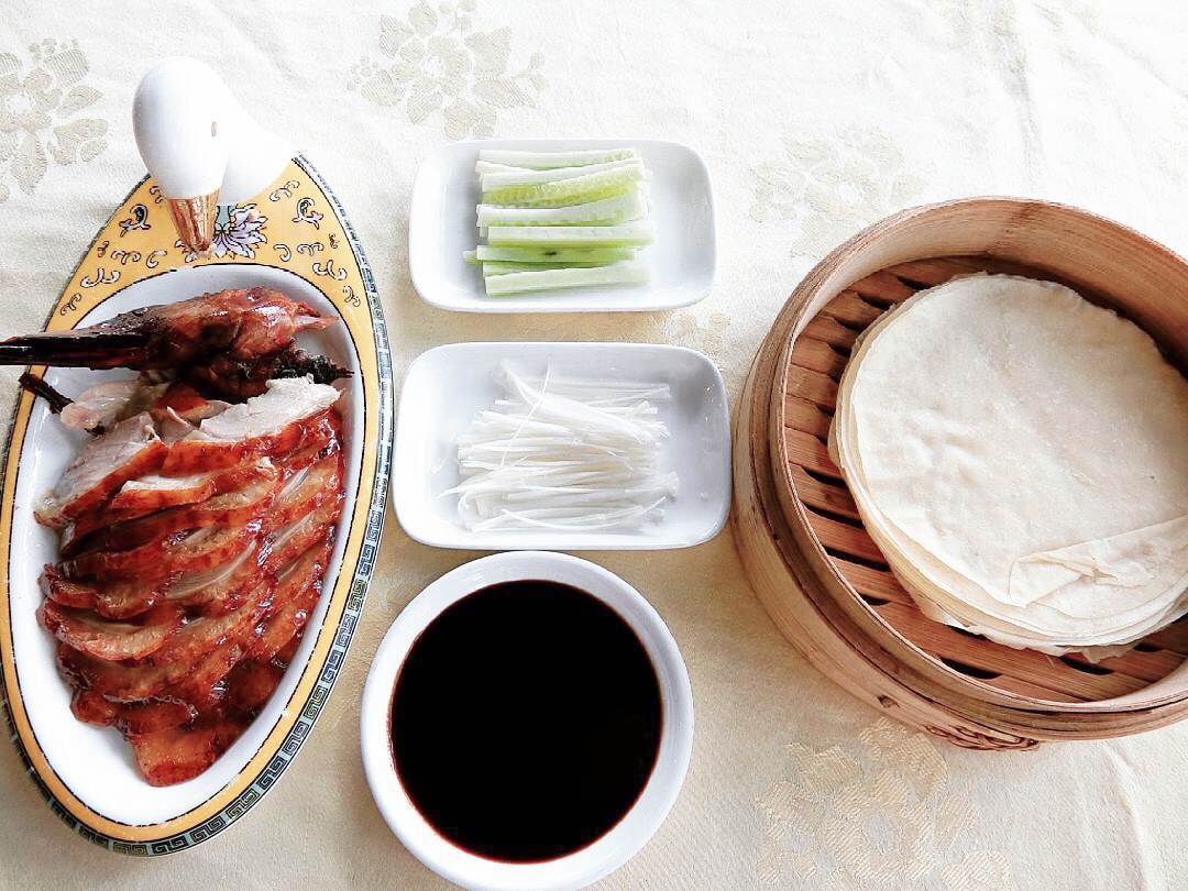 Sliced Peking duck served with traditional condiments