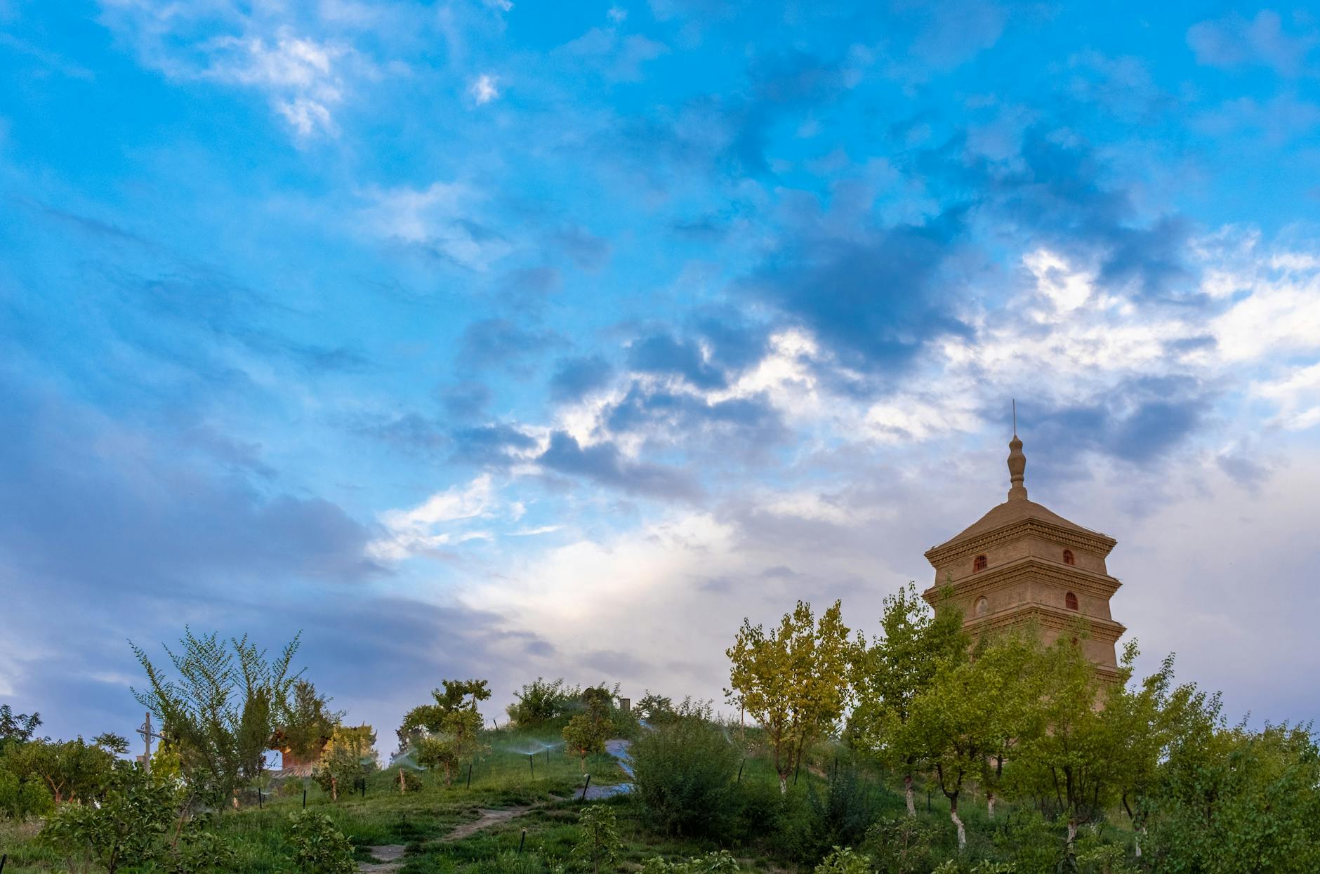 Giant Wild Goose Pagoda stands majestically on a hilltop against a vibrant sky in Xi'an, China.