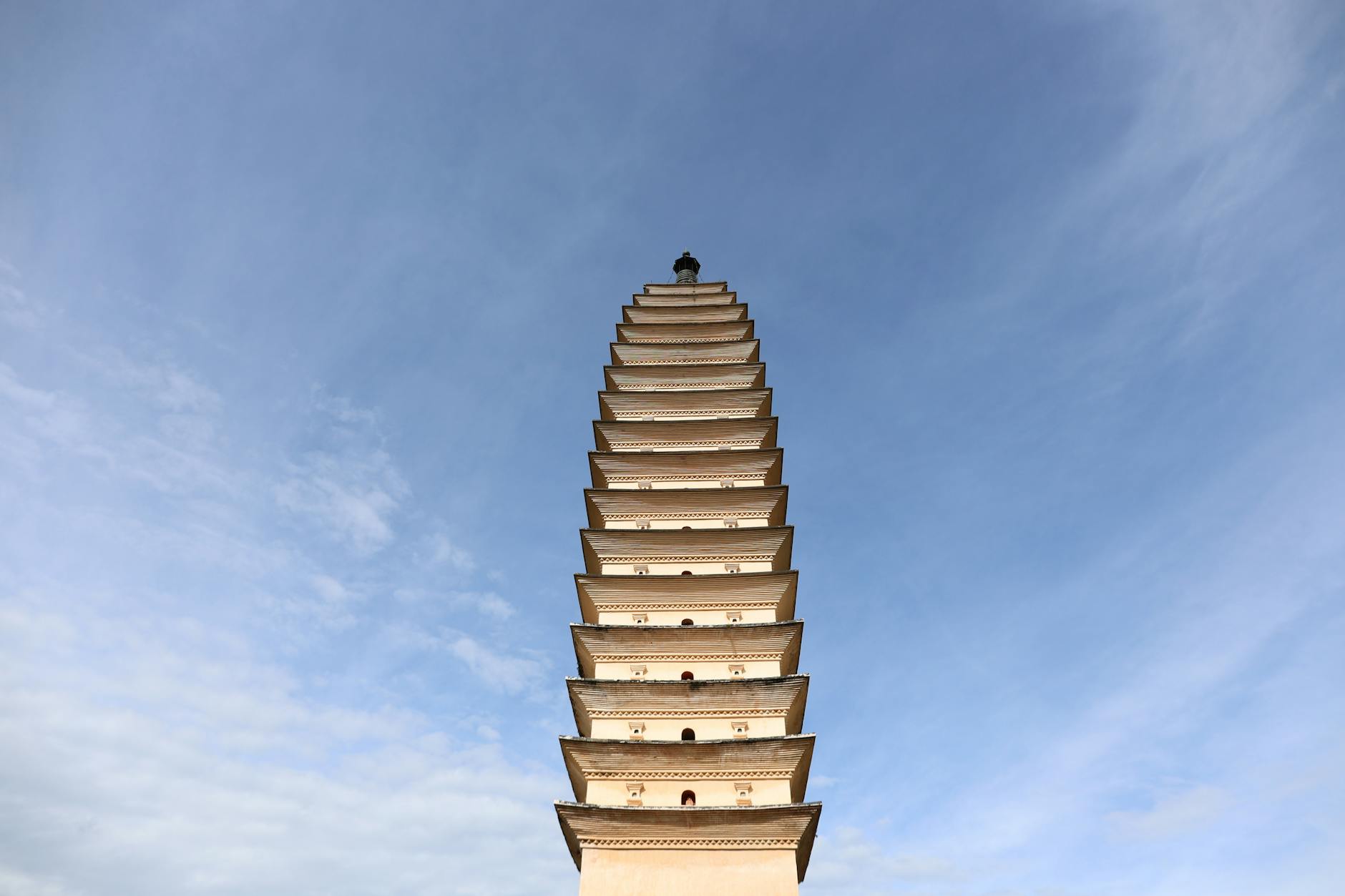 A historic pagoda reaches towards the sky featuring serene architectural beauty against a clear backdrop.