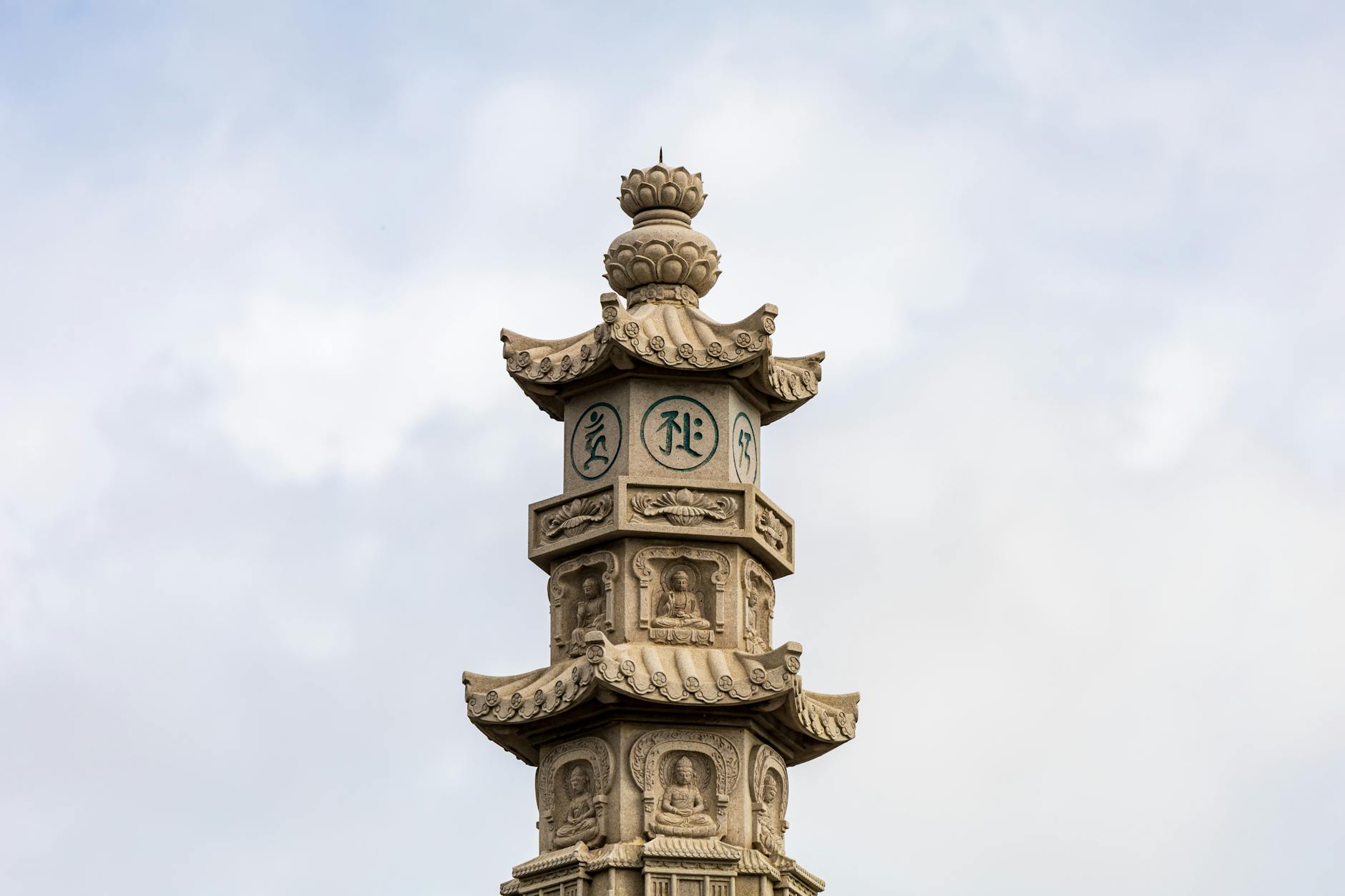 Detailed view of an ornate Buddhist pagoda tower against the sky in Dali, Yunnan, China.