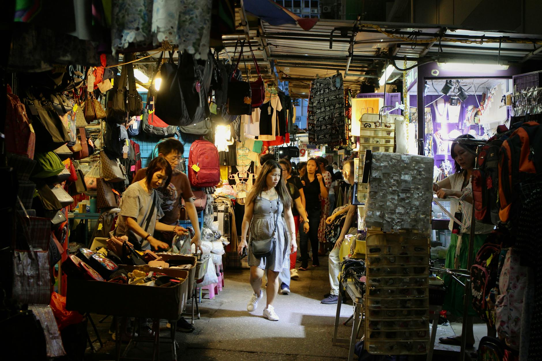 Vibrant scene of people shopping in a lively Hong Kong Island night market.