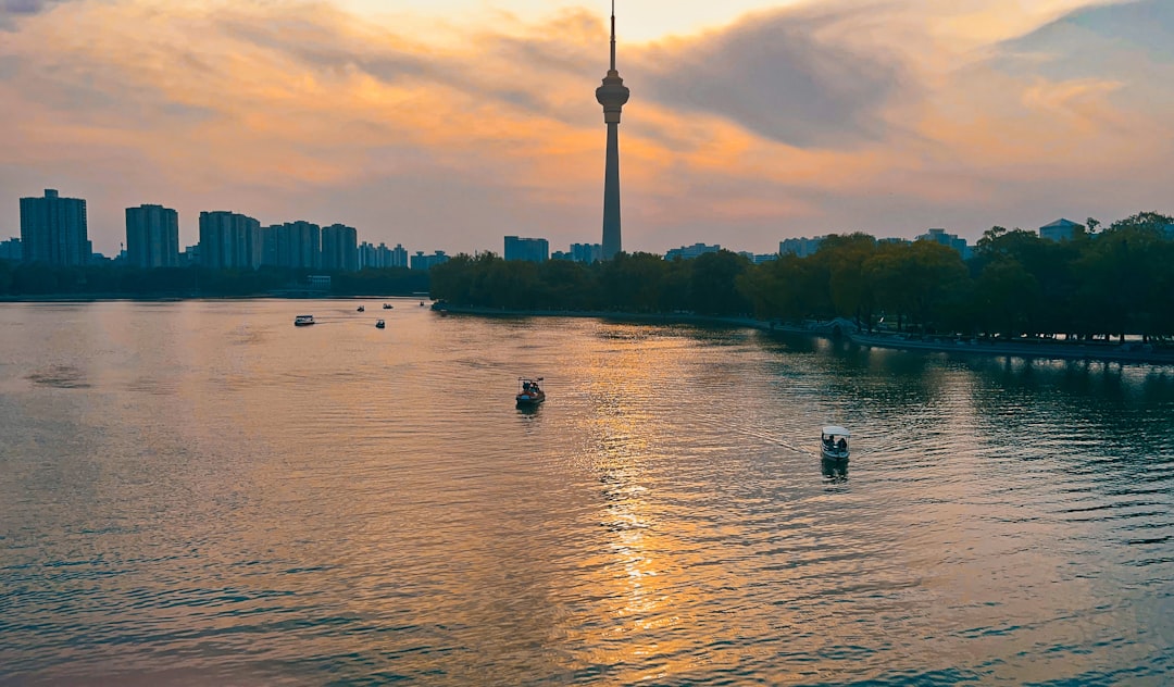 a body of water with boats in it and a city in the background