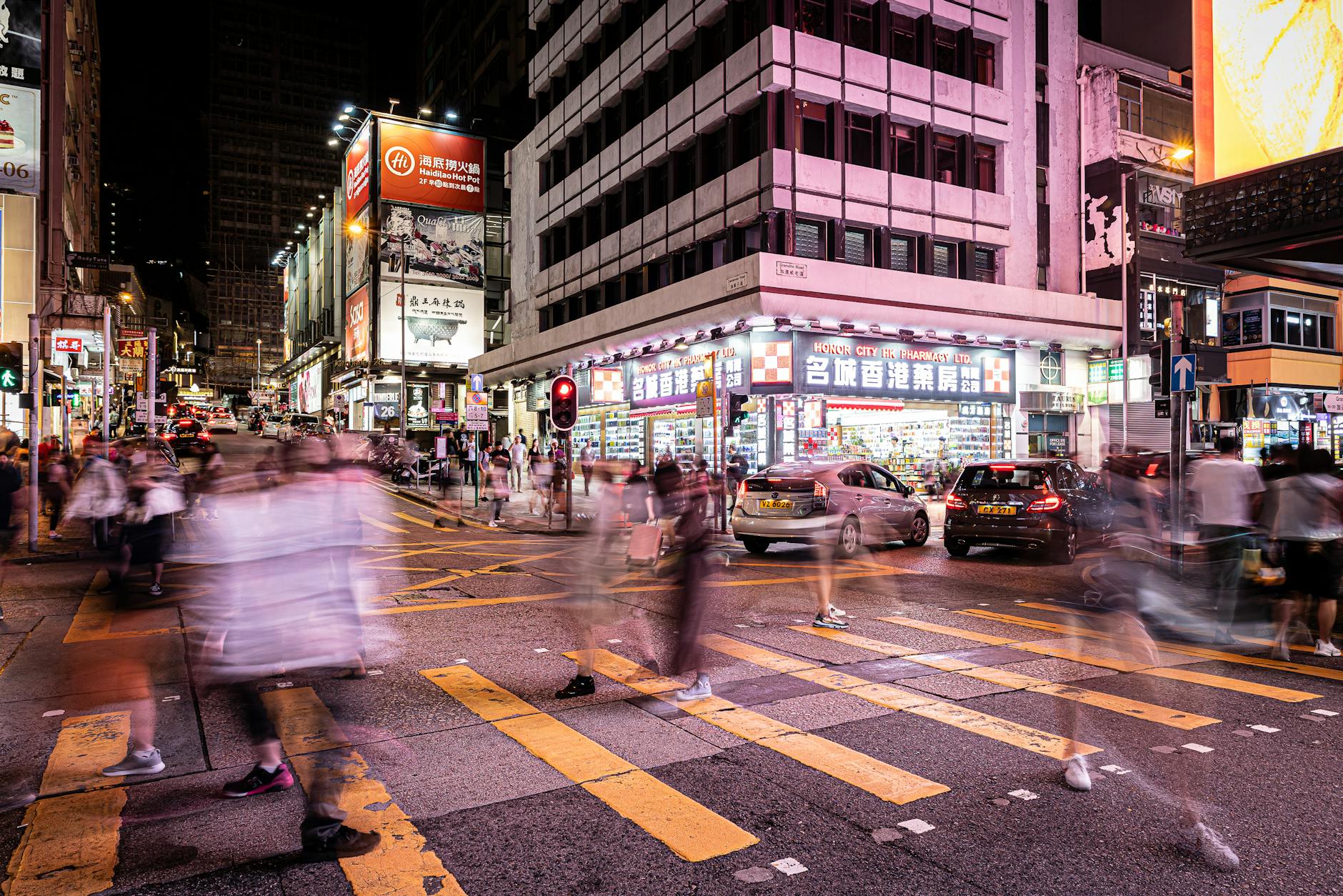 Experience the dynamic nightlife of Hong Kong with blurred motion capturing the busy streets and energetic ambiance.