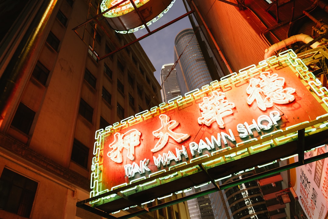 A neon sign in a city at night