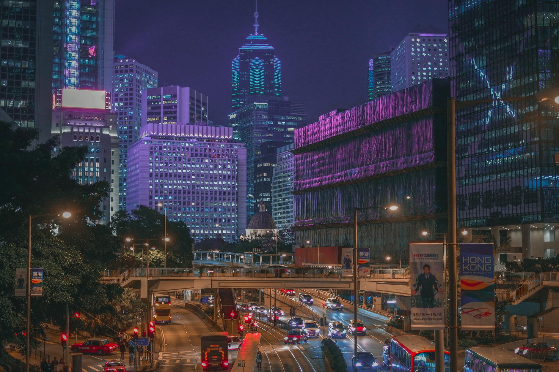 Captivating night view of Hong Kong's illuminated skyscrapers and bustling streets, showcasing urban vibrancy.