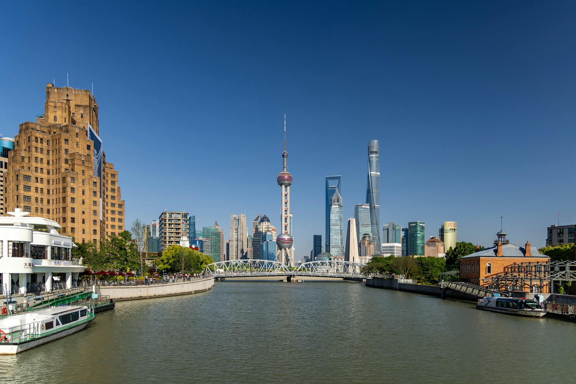 Stunning view of Shanghai's skyline featuring the iconic Oriental Pearl Tower against a clear blue sky.