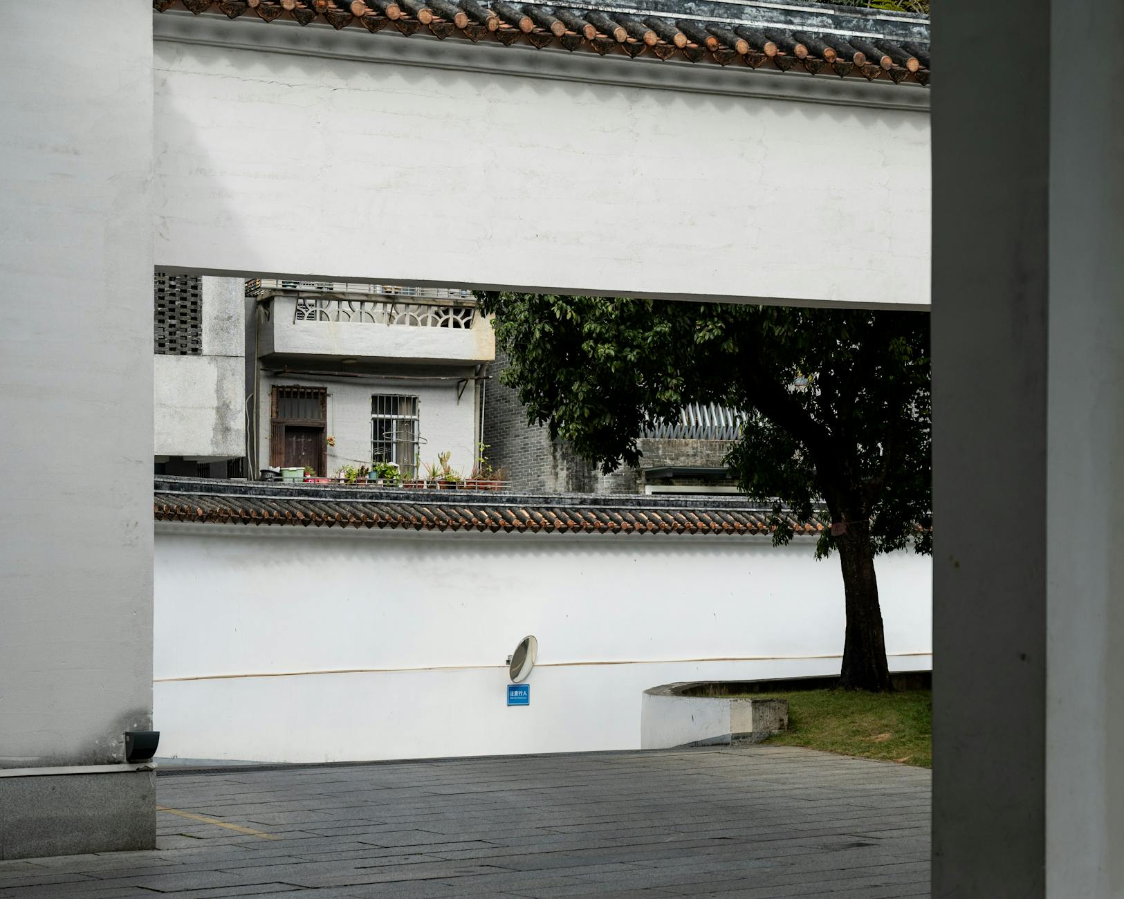 Captivating view of traditional Chinese architecture in Guangzhou, featuring classic brickwork and serene nature.