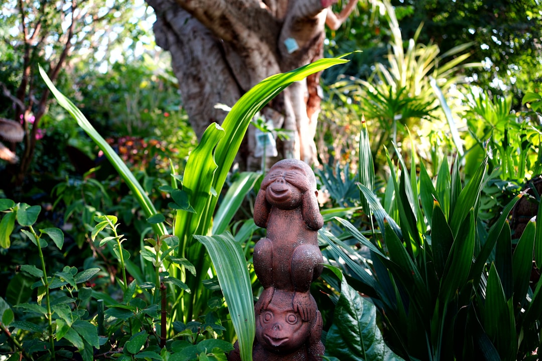 A statue of a dog in the middle of a garden