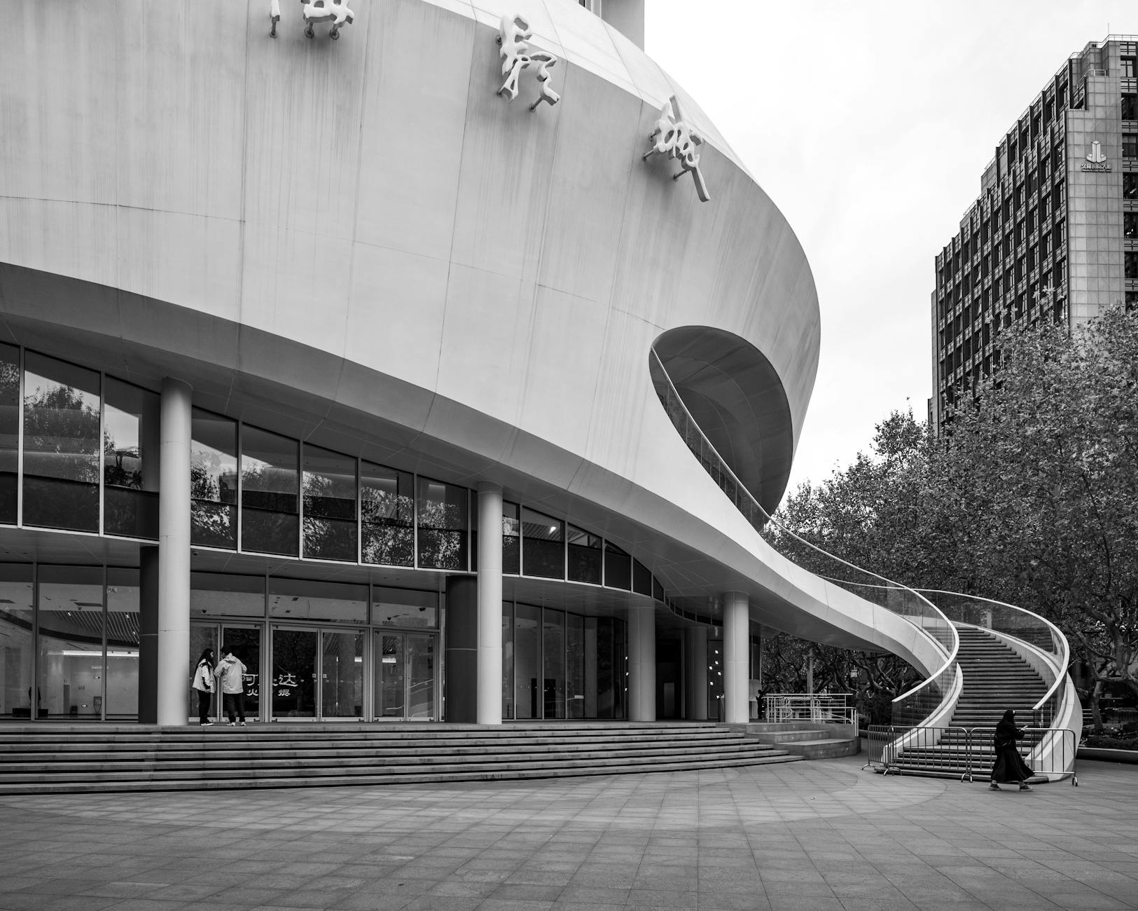 Black and white photo of Shanghai's modern architectural marvel with a spiral staircase.