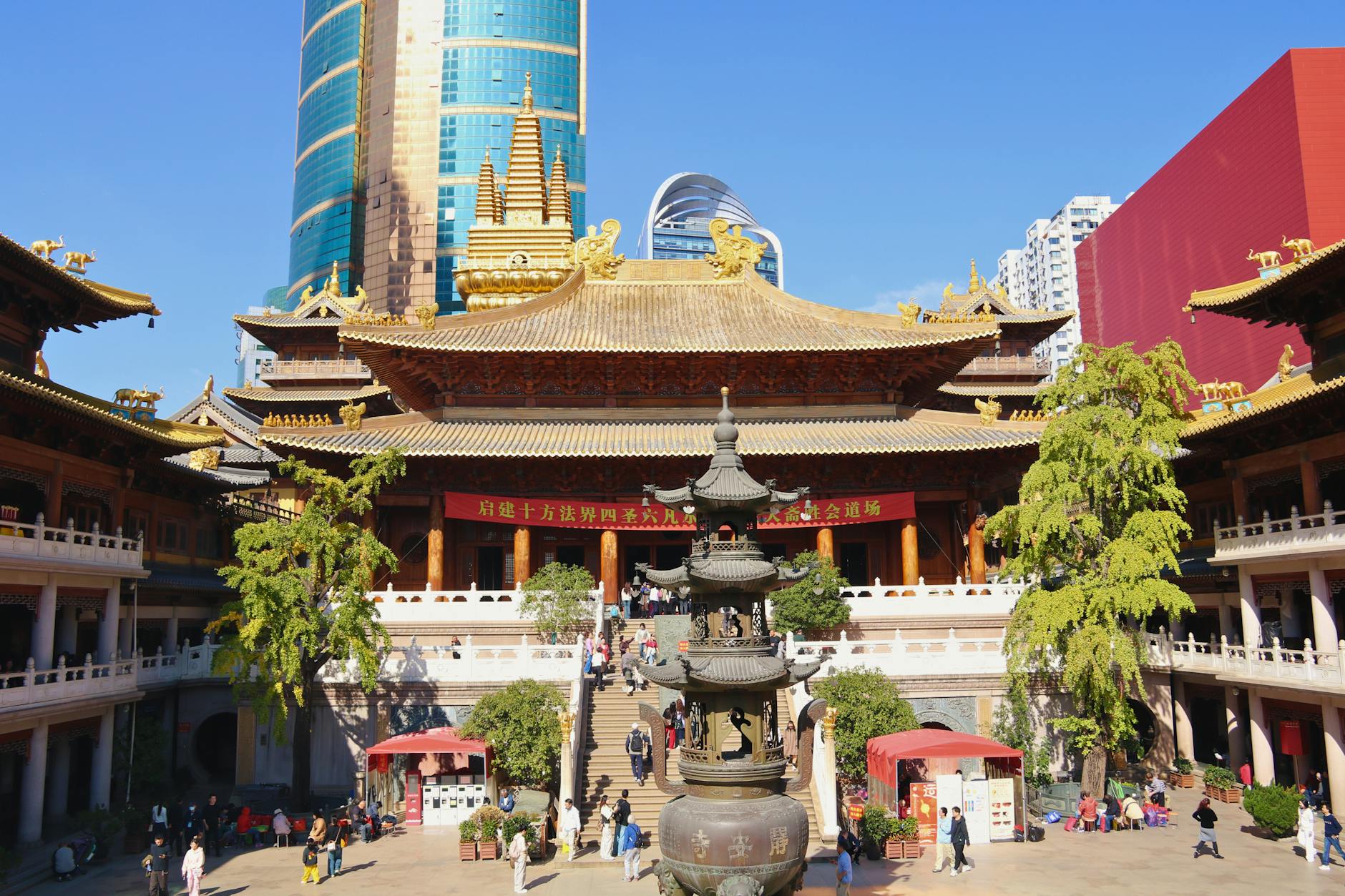 A vibrant scene of Jing'an Temple with modern skyscrapers in Shanghai, China.