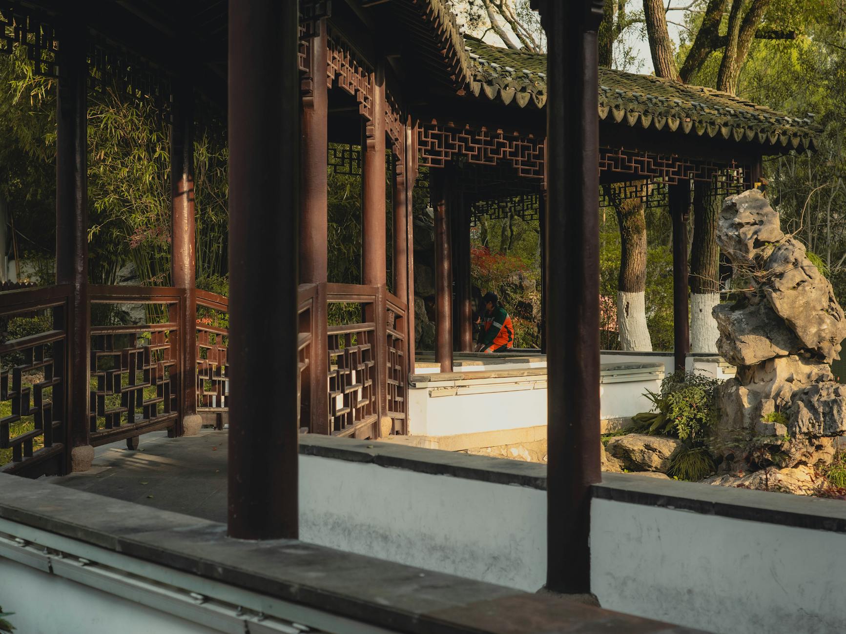 A serene Chinese pavilion nestled in the lush greenery of a Suzhou garden, perfect for relaxation and reflection.