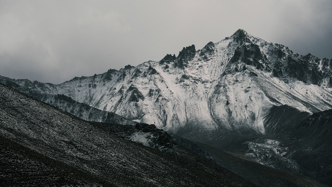 A snow covered mountain with a cloudy sky
