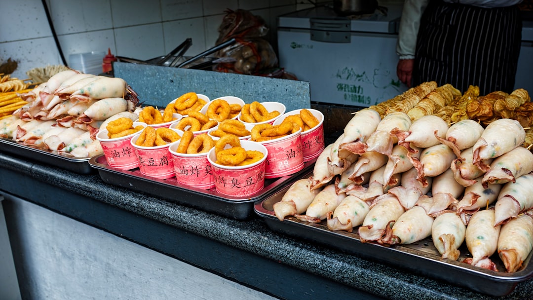 Several trays of food sitting on a counter