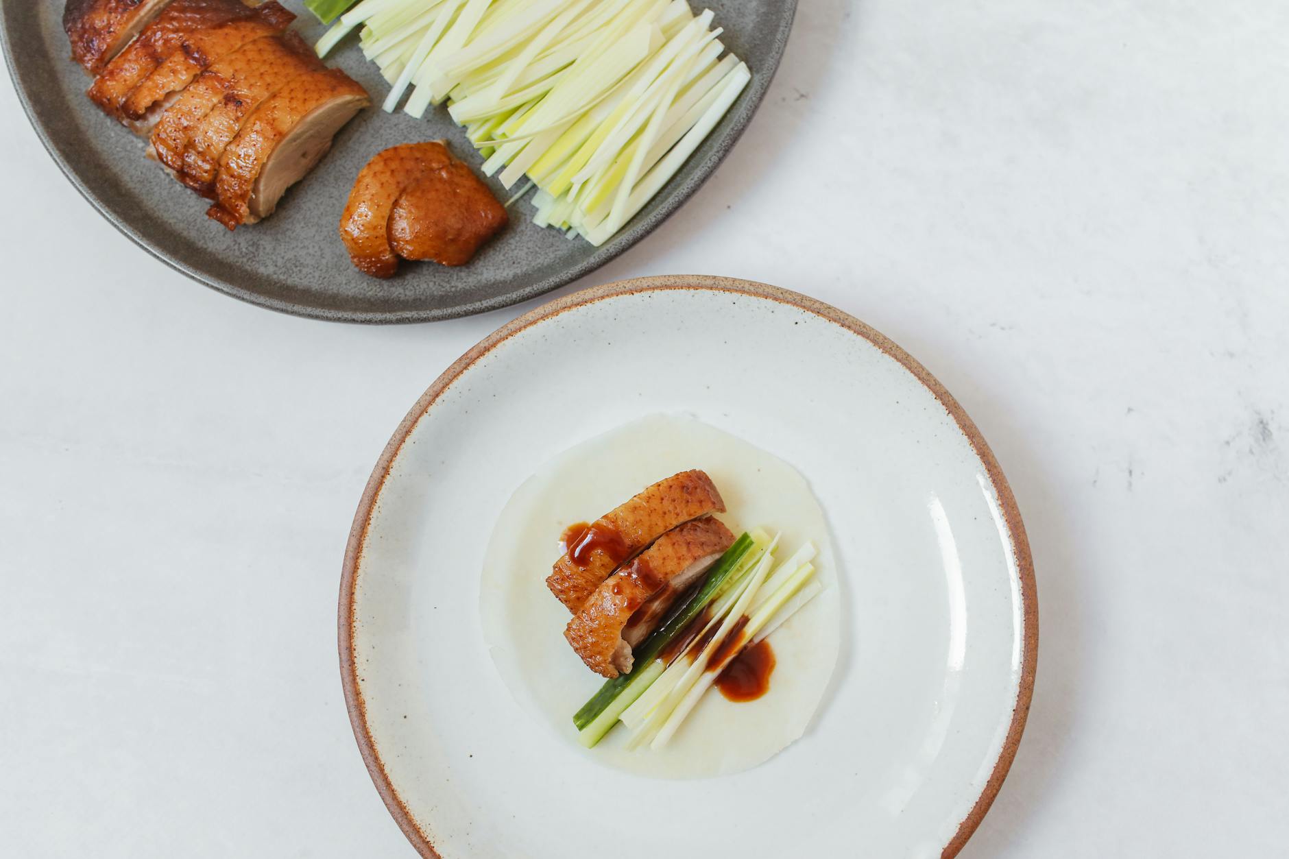 Close-up of savory Peking duck with sliced veggies, ideal for food enthusiasts.