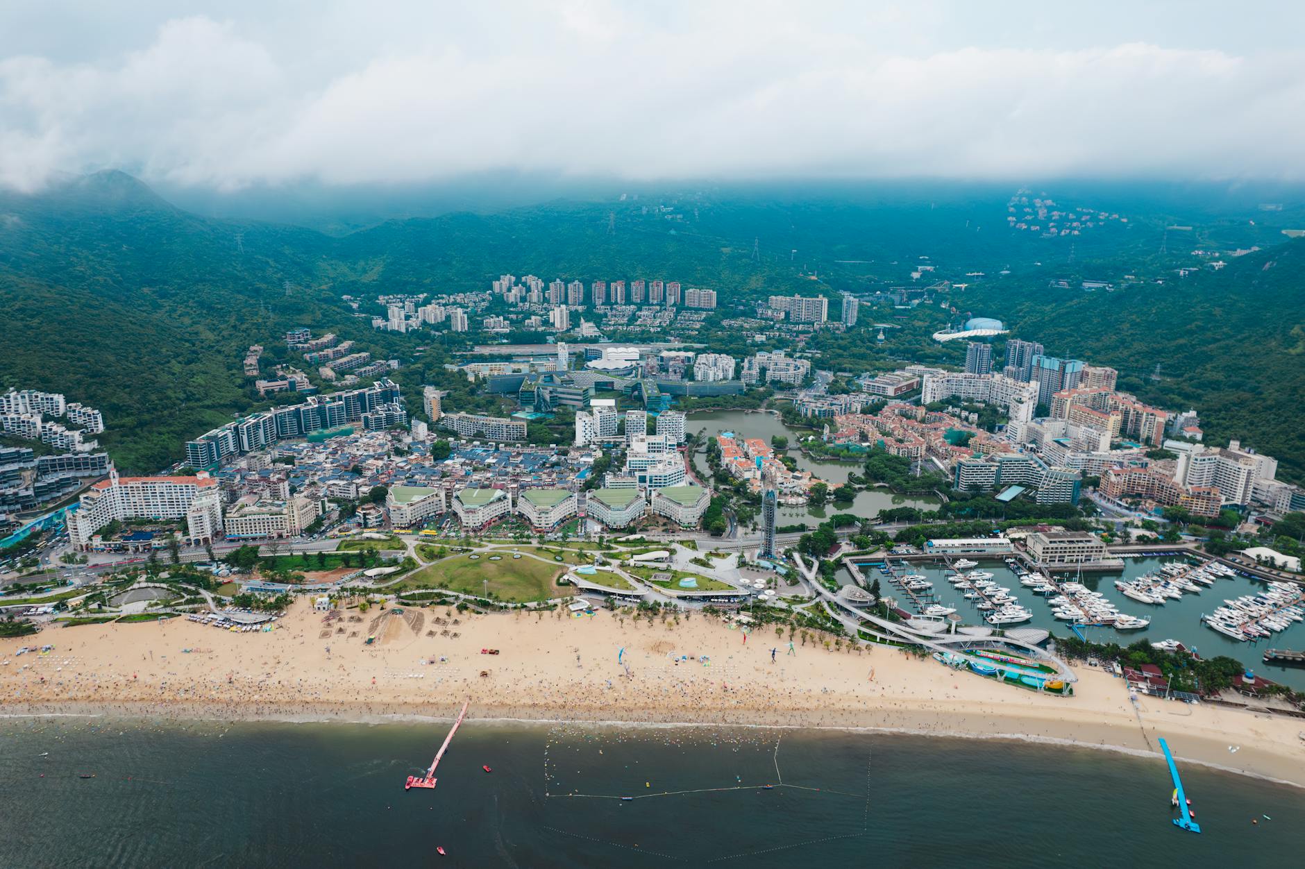 Stunning aerial view of Shenzhen's coastline, showcasing city, beach, and marina.