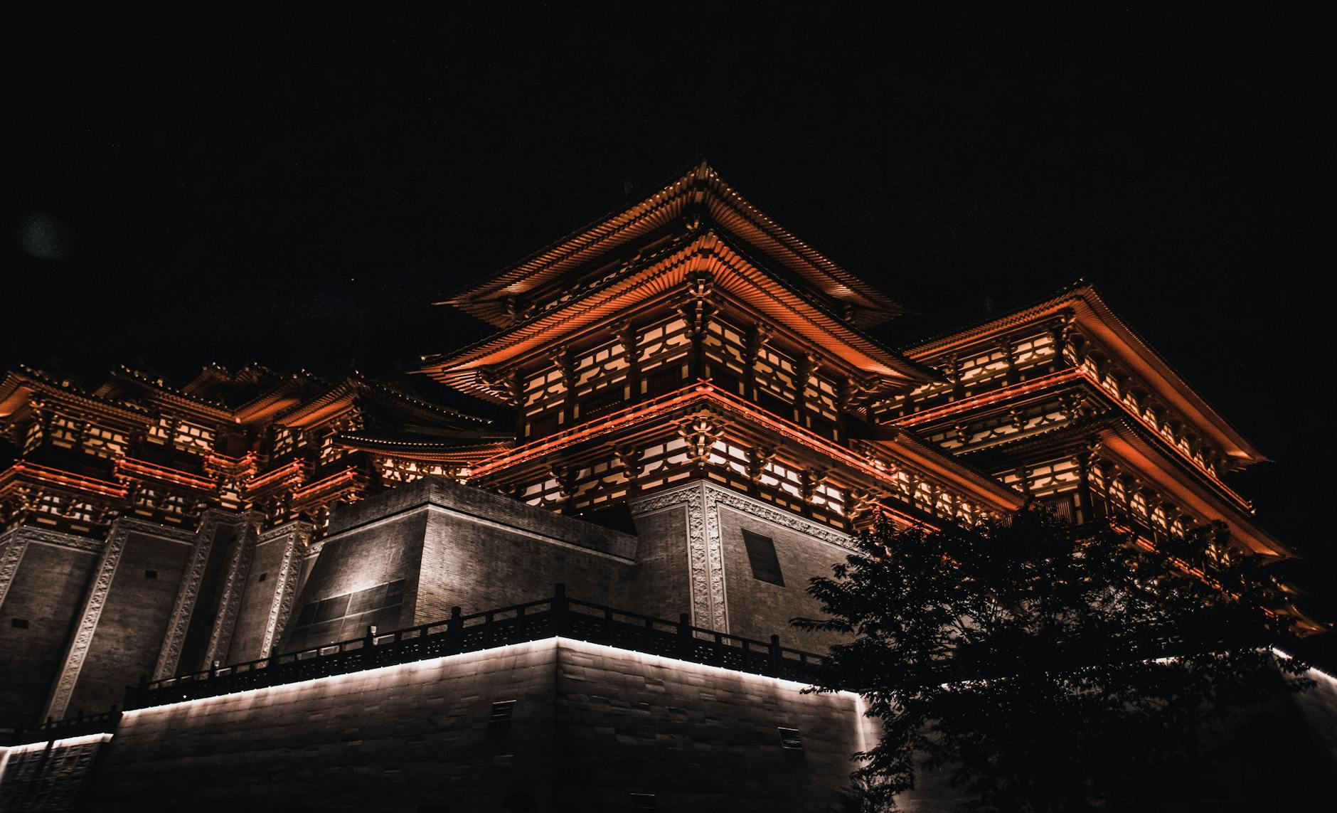 Beautifully illuminated traditional Chinese architecture at night in Luoyang, Henan.