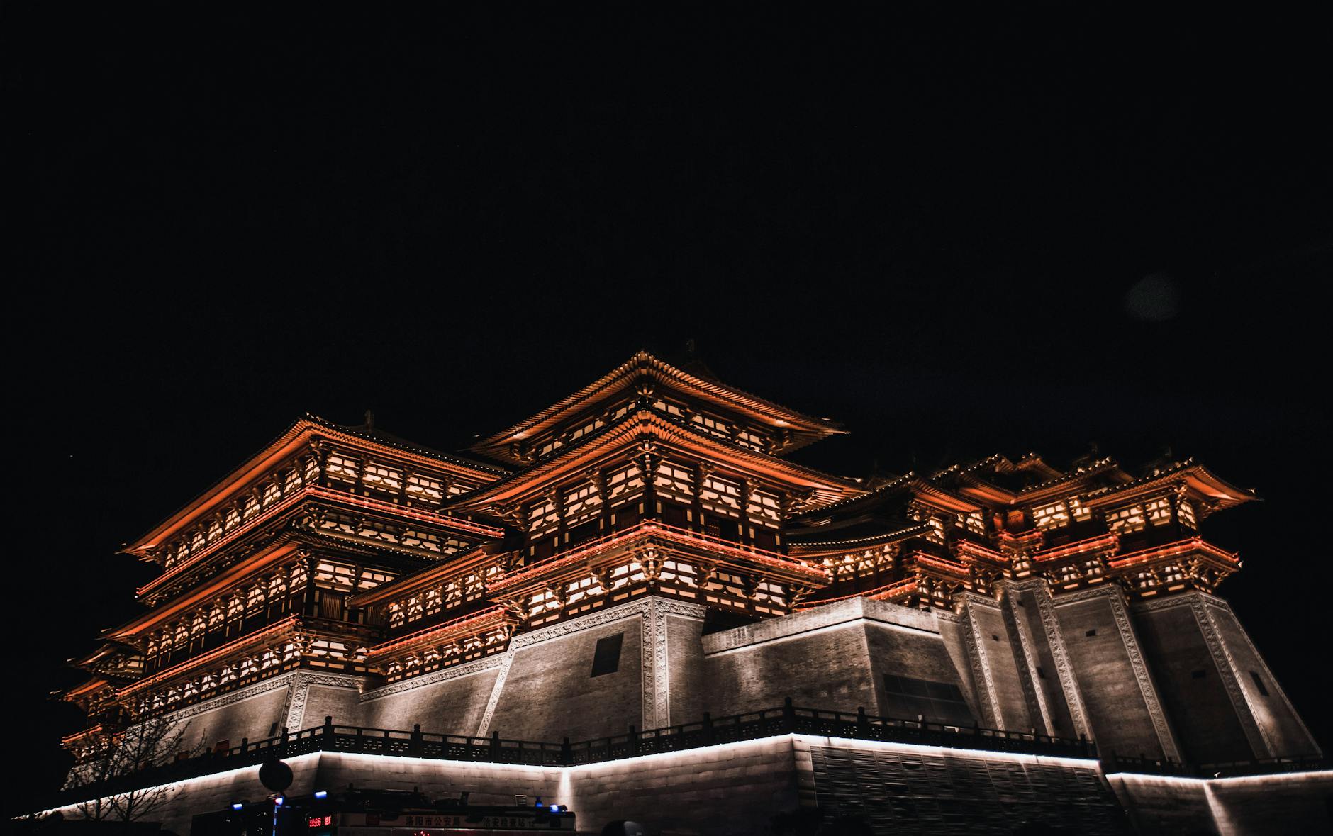 Stunning nighttime view of Tang Paradise in Luoyang, showcasing traditional Chinese architecture.