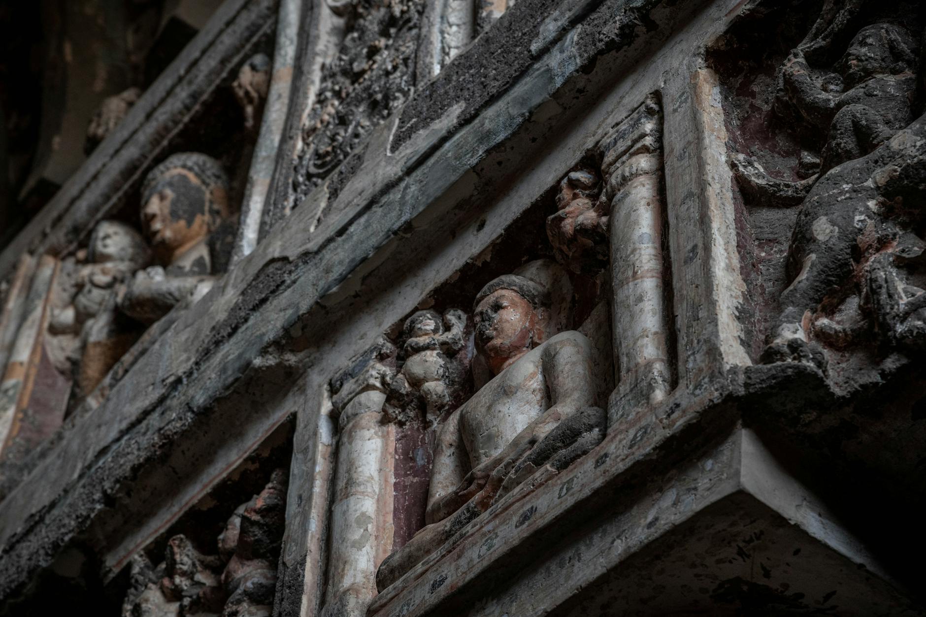 Detailed view of ancient sculptures in Ajanta Caves, showcasing historic artistry.