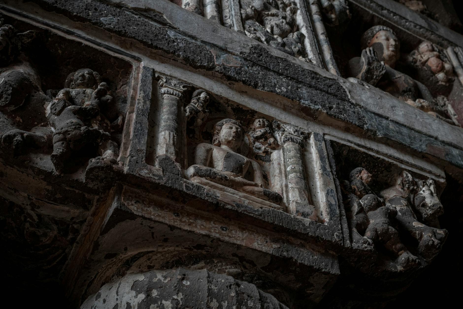 Detailed view of ancient sculptures in Ajanta Caves, Maharashtra, showcasing historical artistry.