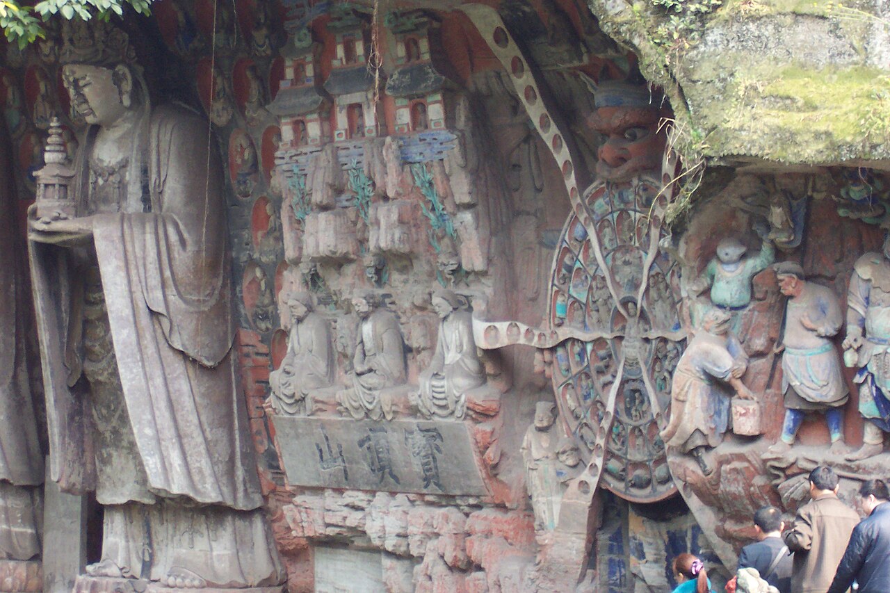 Dazu rock carvings, including circle of life and giant Buddha. From right to left: Scenes #2 (partial), 3, 4, and 5 (partial).