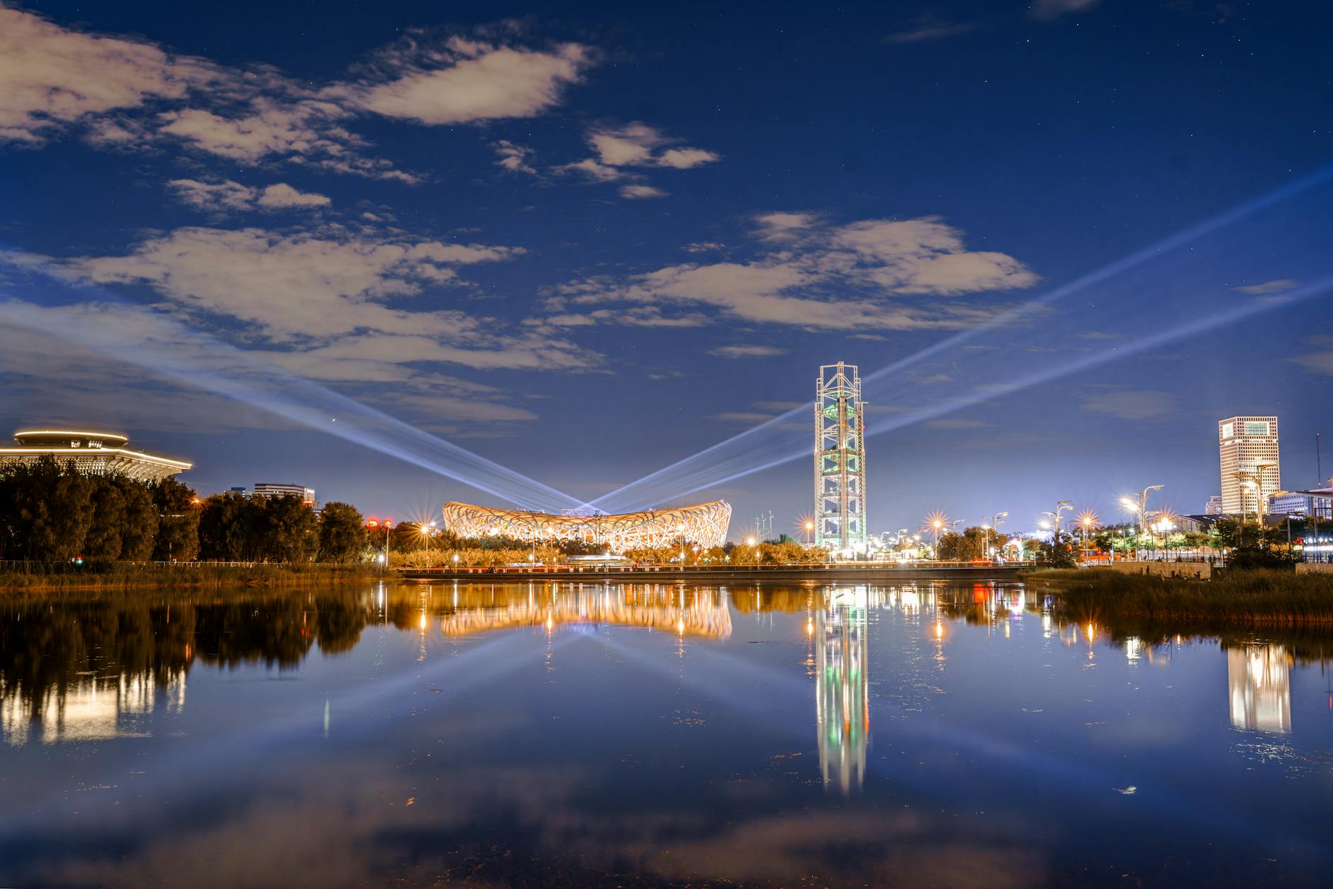 A breathtaking night view of Beijing's architecture with reflections on the water.