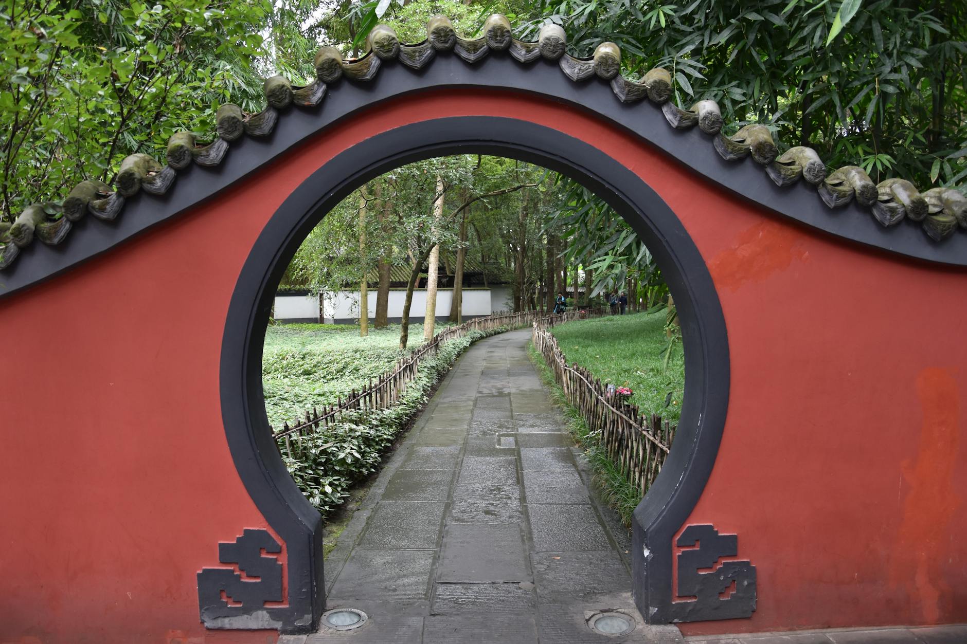 Explore serenity through a traditional Chinese garden archway at Du Fu Thatched Cottage in Chengdu.