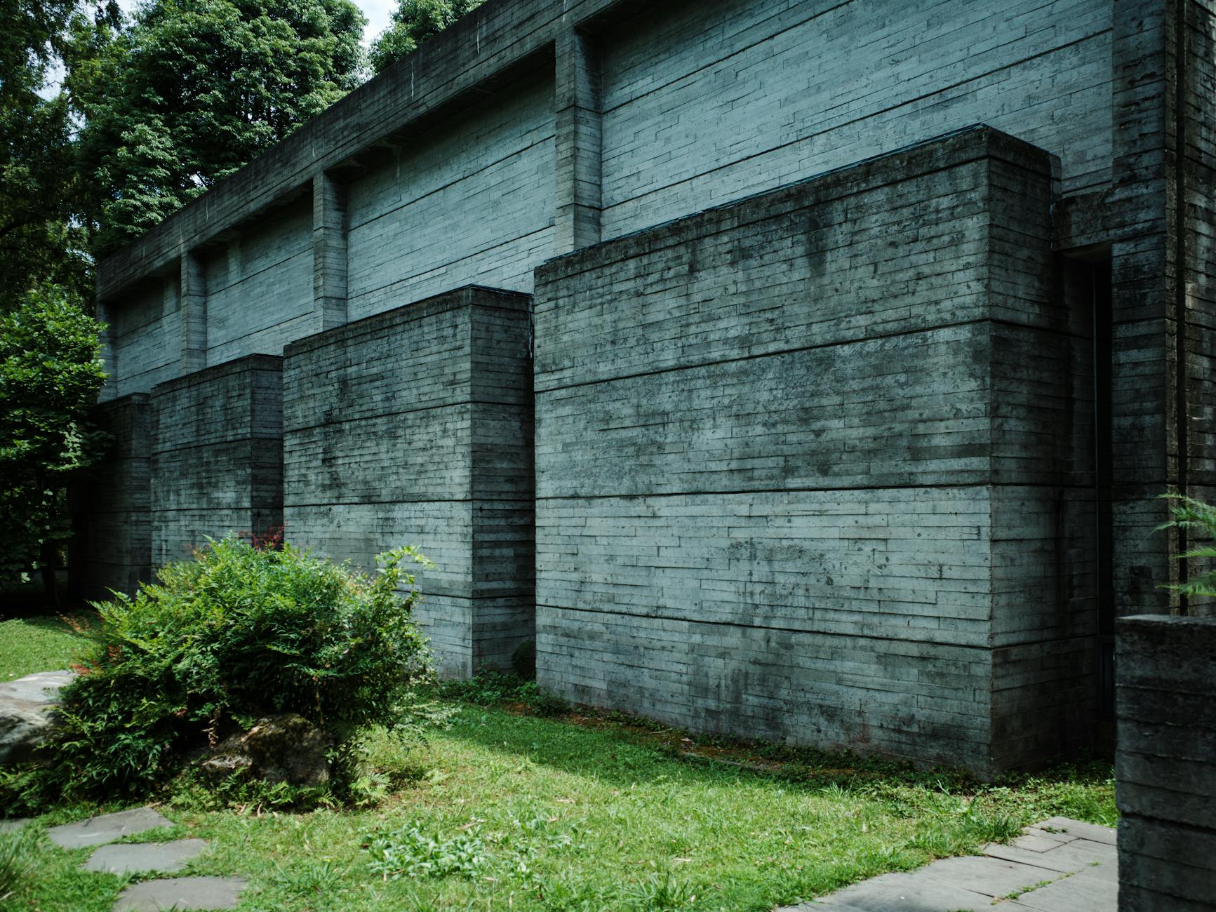 Concrete architecture blending with lush greenery in Chengdu, Sichuan, China.