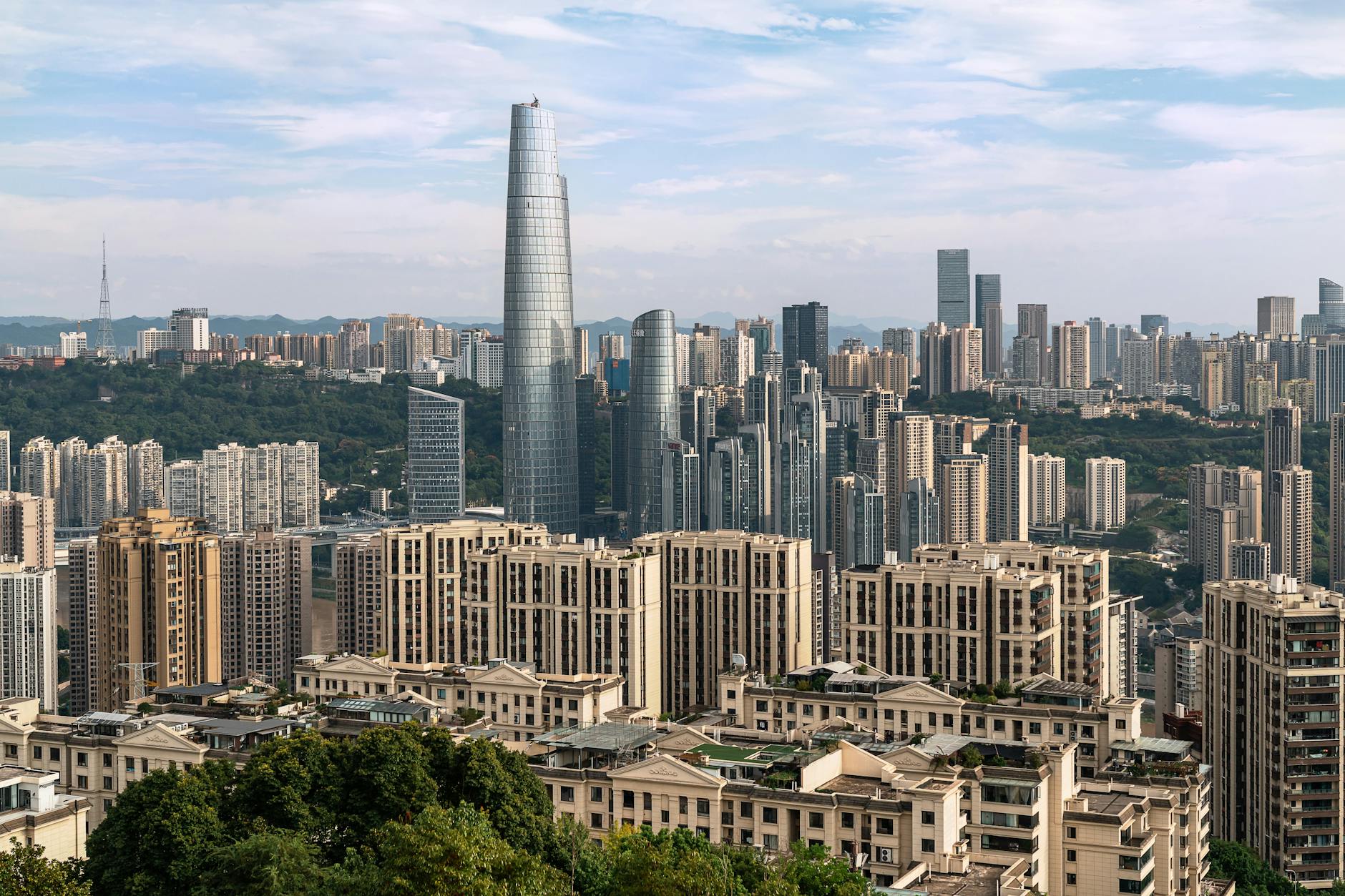 A dynamic cityscape showcasing tall skyscrapers under a clear sky, highlighting urban architecture.