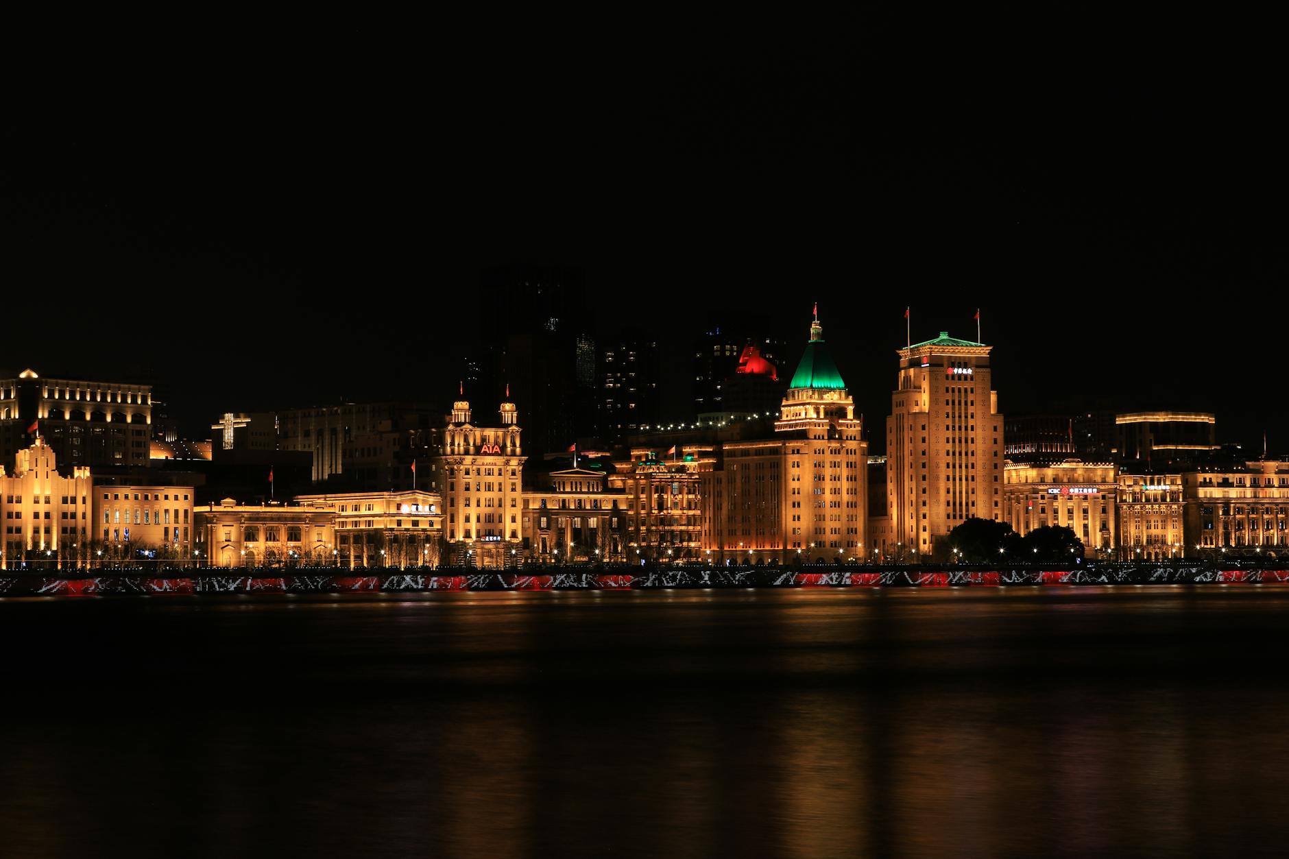 Stunning night view of Shanghai's Bund, showcasing illuminated historic buildings along the waterfront.