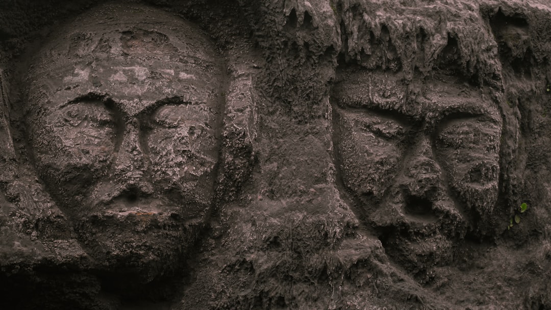 a close up of a face carved into a wall