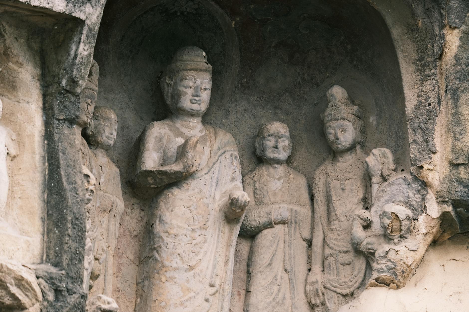 Close-up of historical Buddhist stone carvings in a cave.