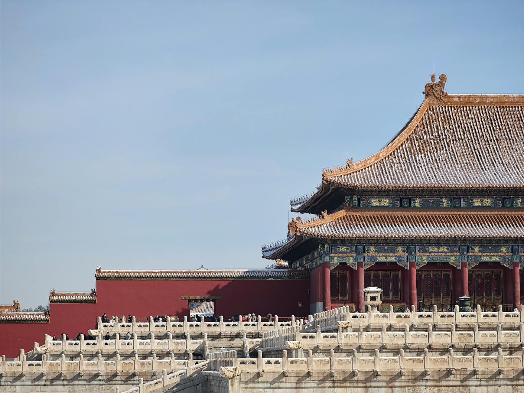 Explore the snow-dusted grandeur of Beijing's Forbidden City, showcasing traditional Chinese architecture under a clear winter sky.