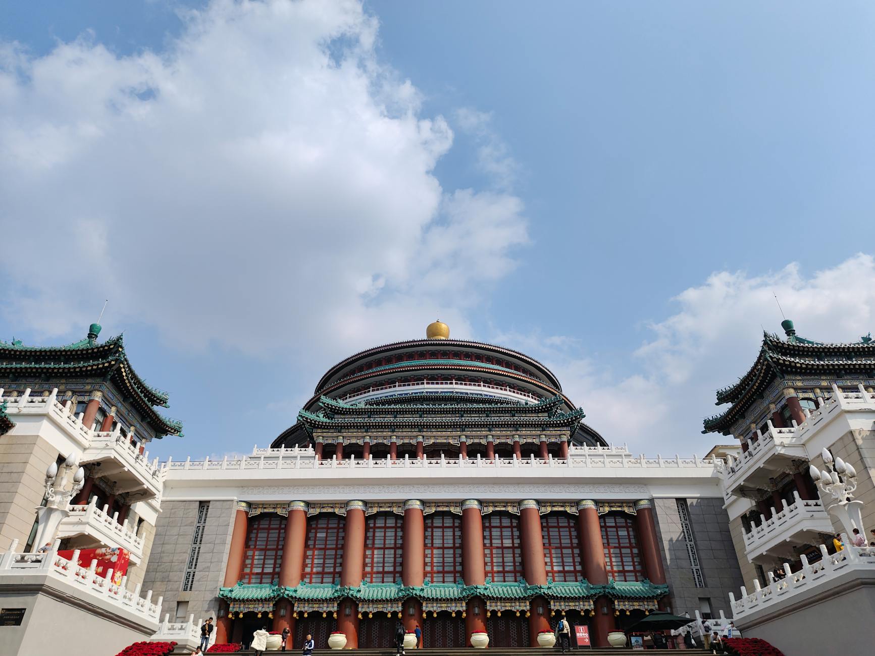 Front view of the Great Hall of the People in Chongqing highlighting its grand architecture under clear skies.