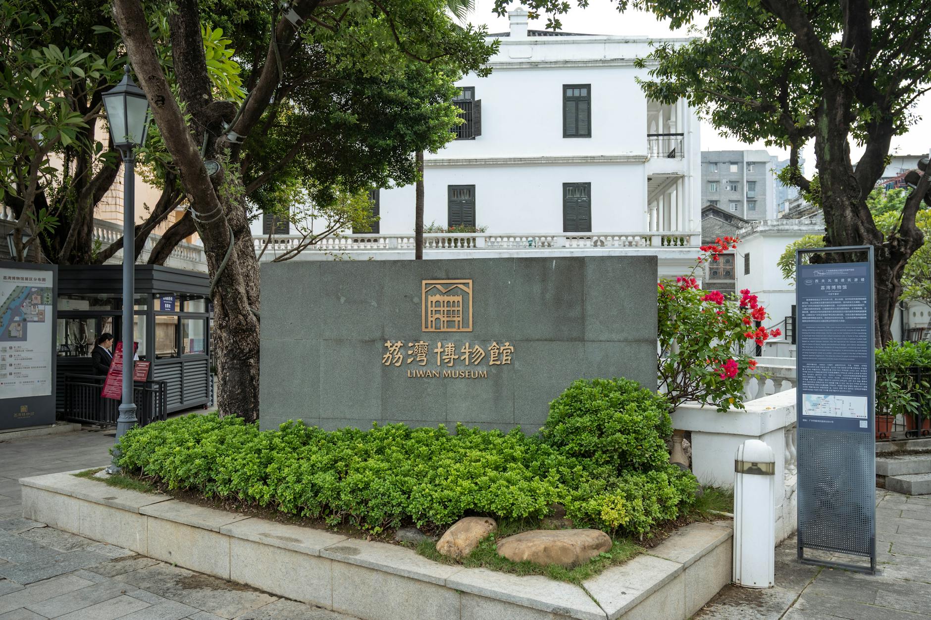 Stone entrance sign and garden at Liwan Museum, Guangzhou, captured during the day.