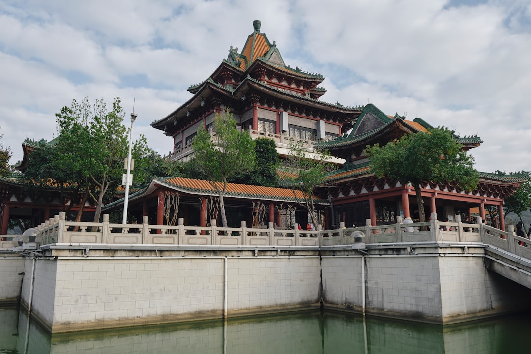a bridge over a body of water with a building in the background