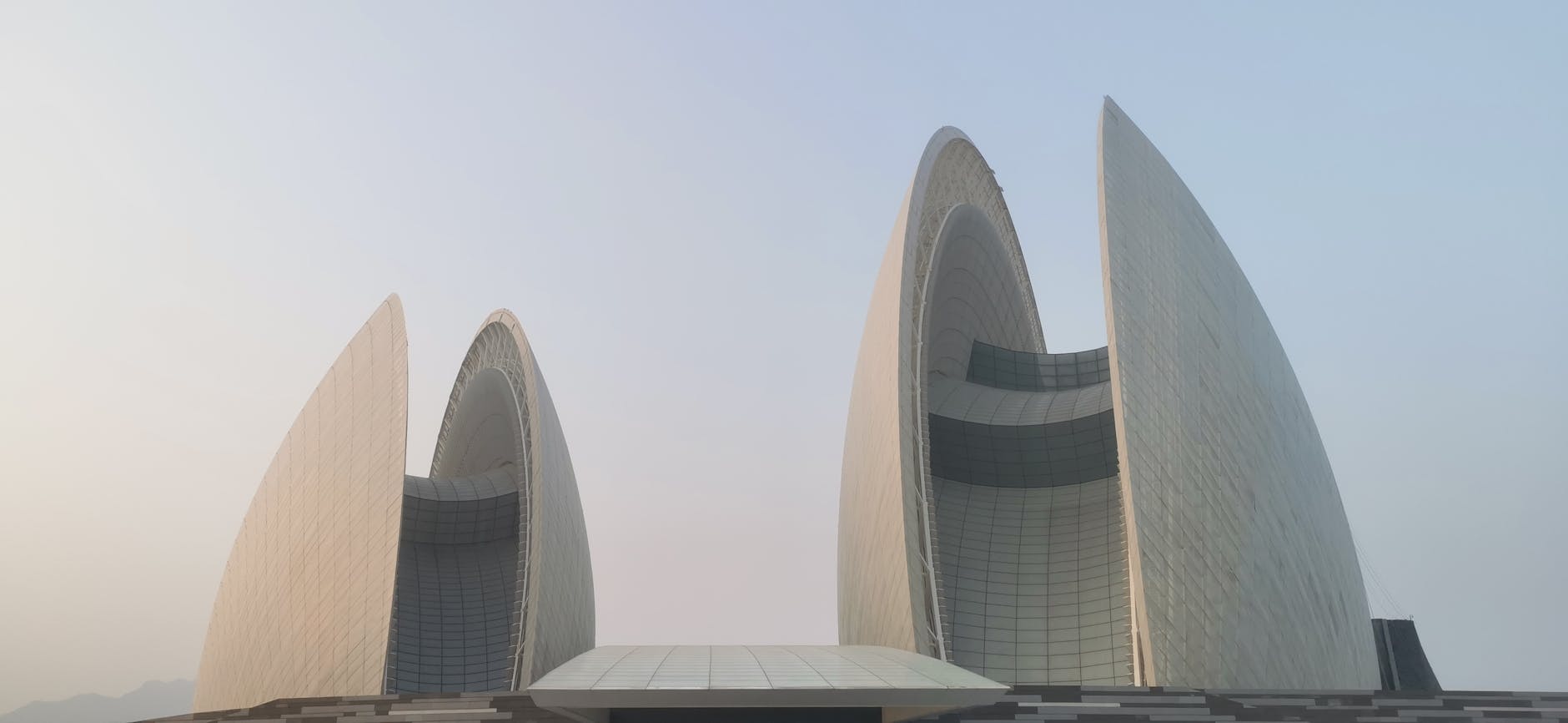 Stunning view of the futuristic Zhuhai Opera House in Guangdong, China with clear sky backdrop.