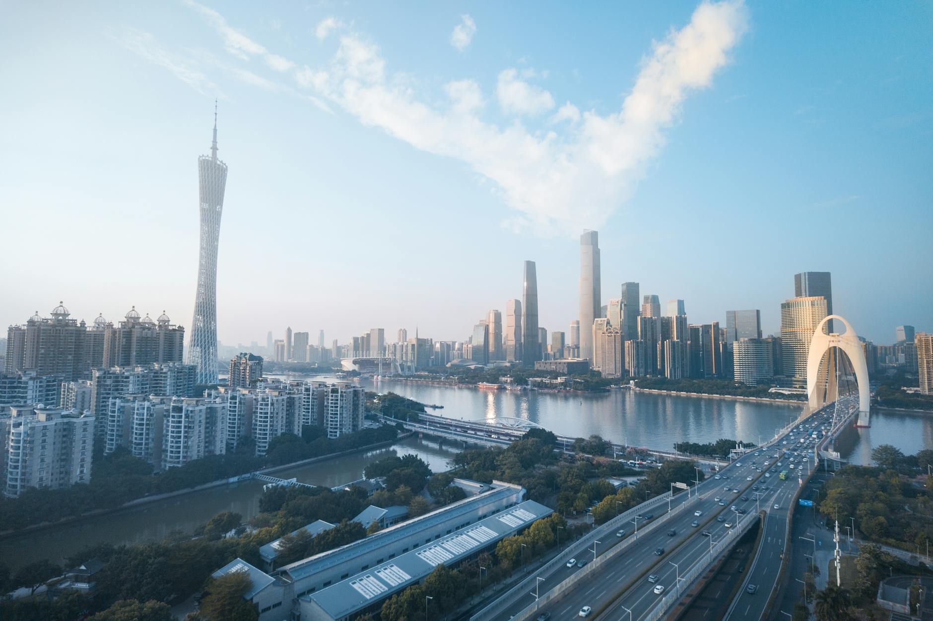 Panoramic aerial shot of Guangzhou skyline with Canton Tower and modern architecture.