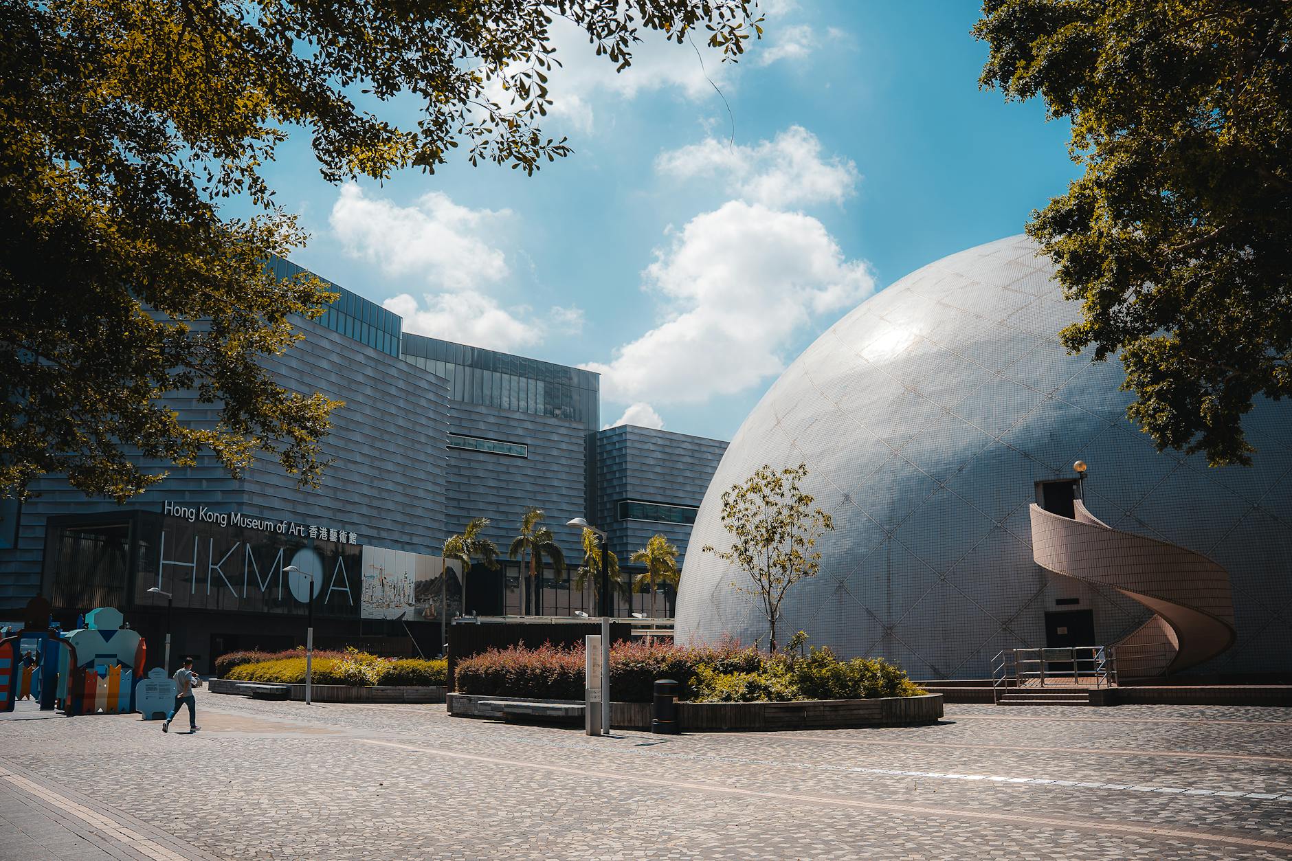 Photo of Hong Kong Space Museum dome and Hong Kong Museum of Art under a sunny sky.