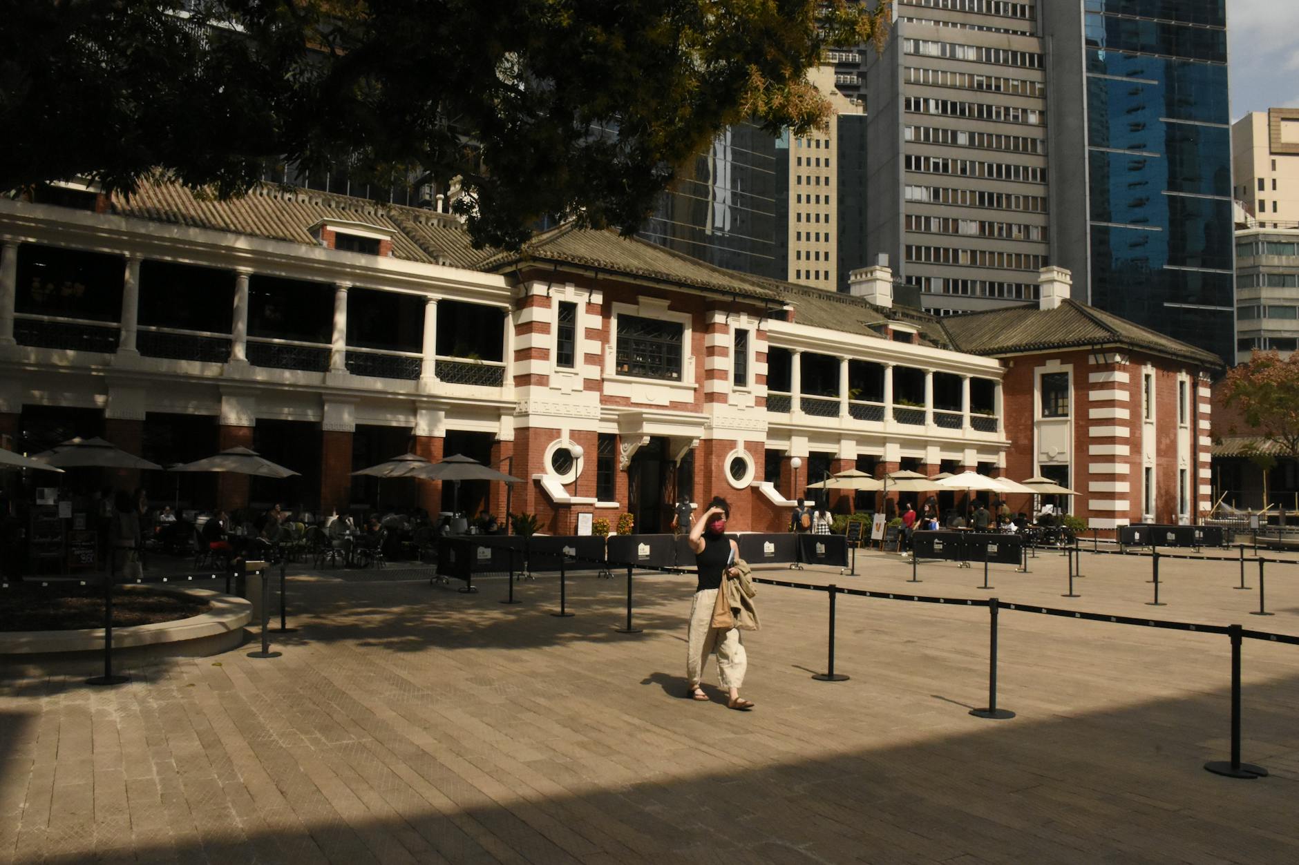 A vibrant city scene showcasing a historic building against a modern skyline during the day.