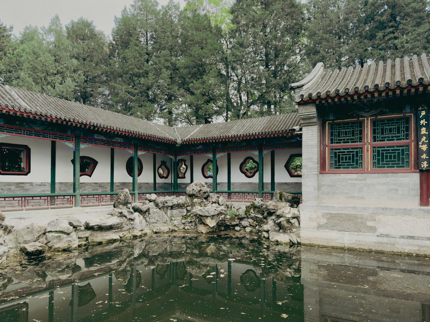 Tranquil scene of Humble Administrator's Garden with pond and traditional Chinese architecture.