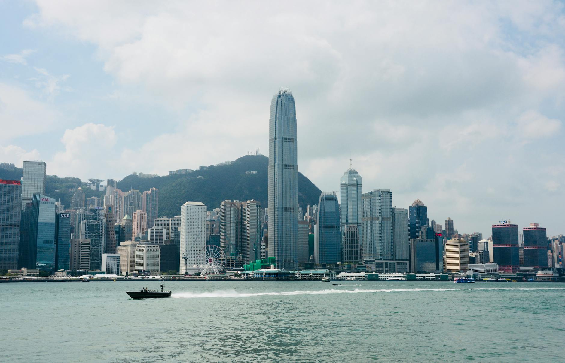 View of Hong Kong's skyline featuring Victoria Harbor with a clear blue sky and skyscrapers.