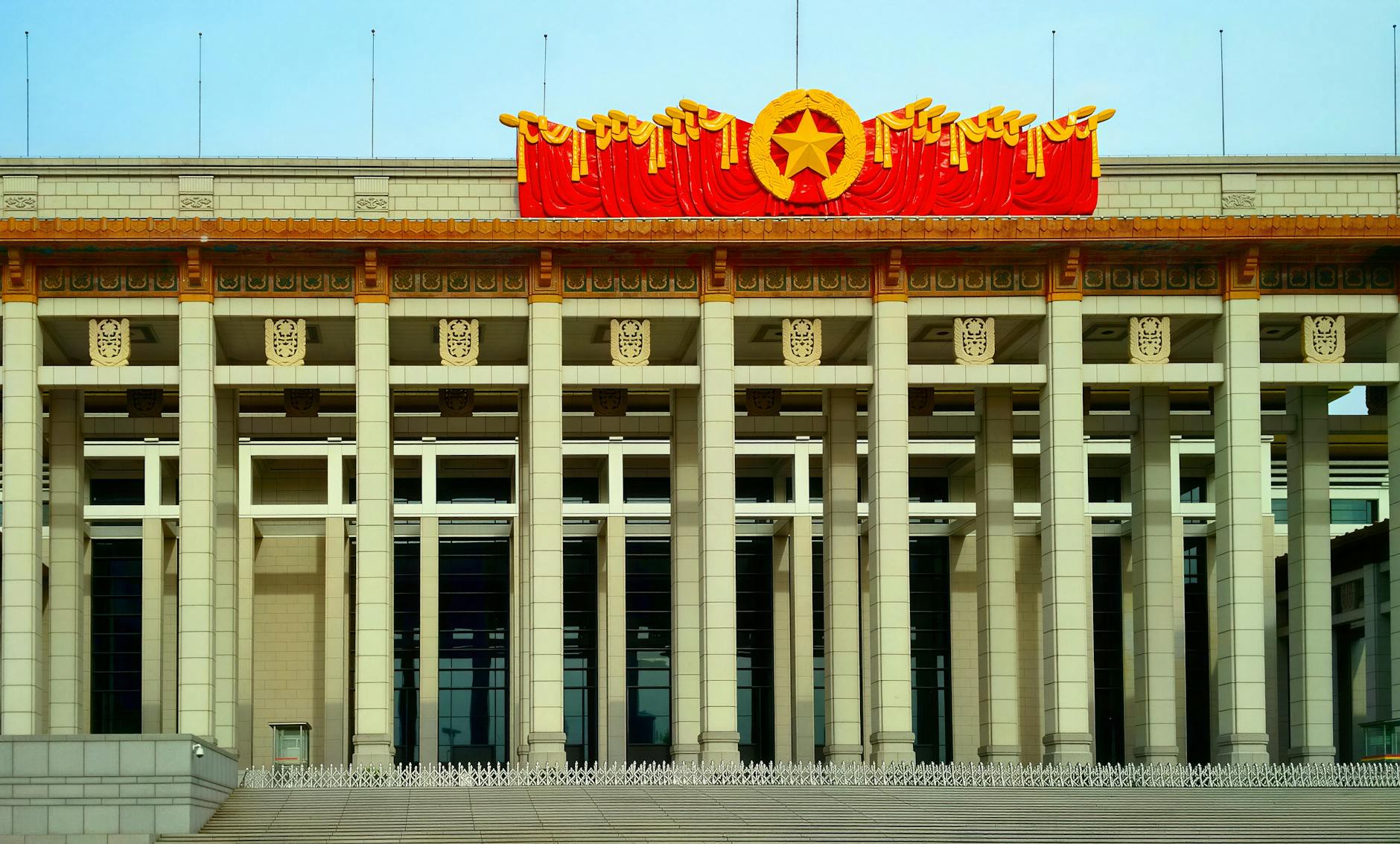 A grand civic center in Beijing with pillars and Chinese cultural motifs.