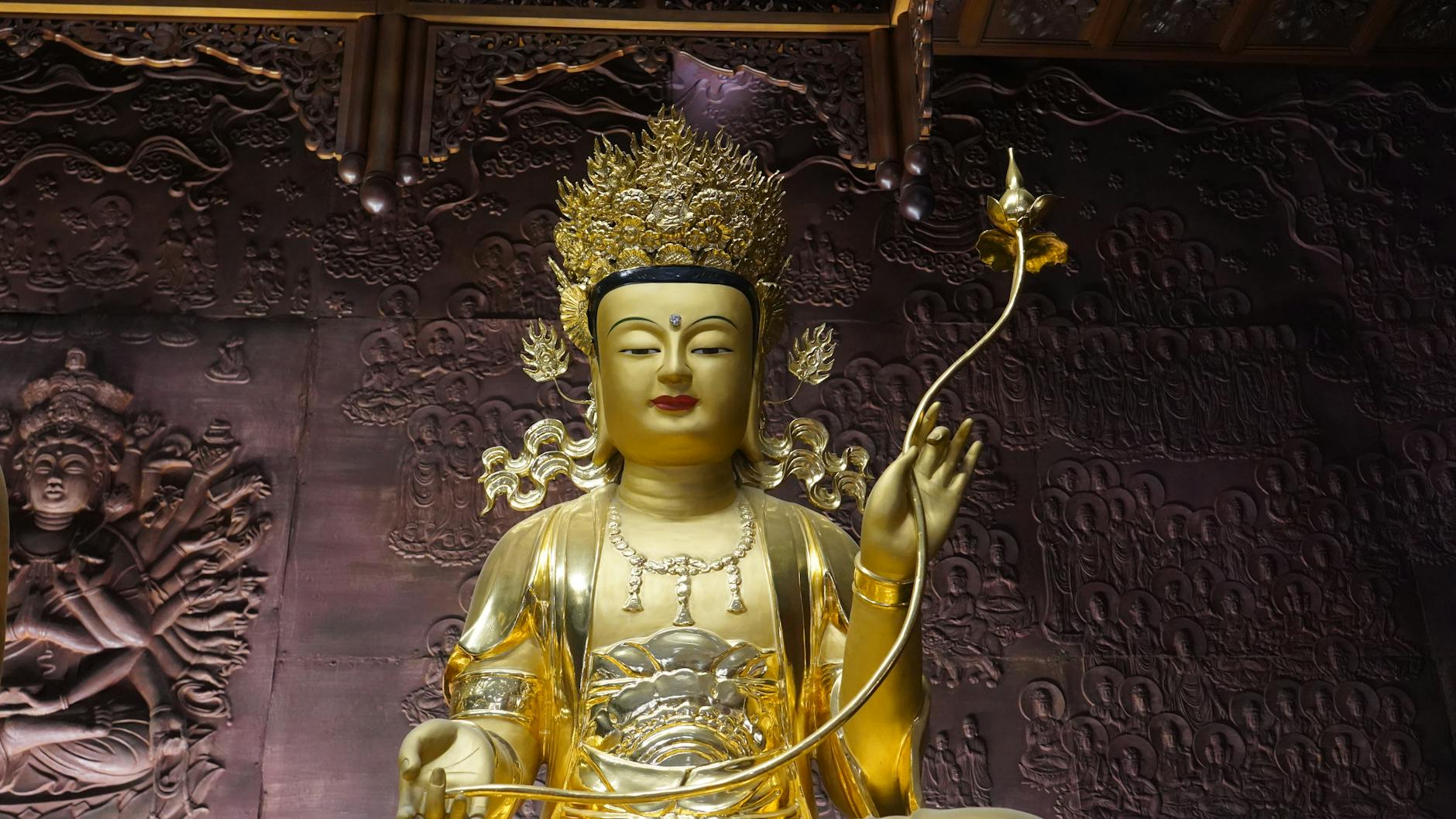 Golden Buddha statue with intricate carvings in a Seoul temple.
