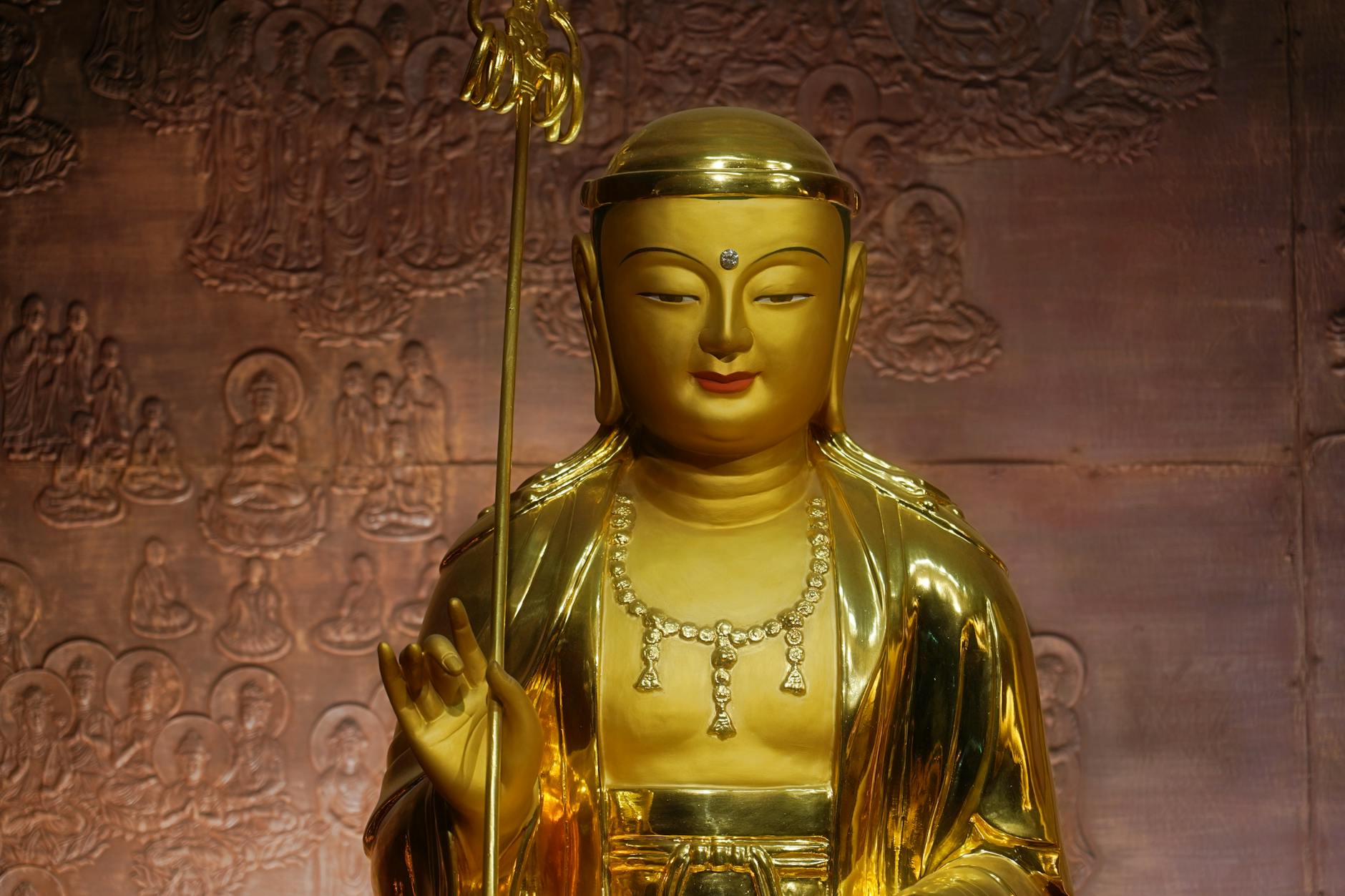 Golden Buddha statue in a temple in Seoul, South Korea, showcasing spiritual serenity and artistic craftsmanship.