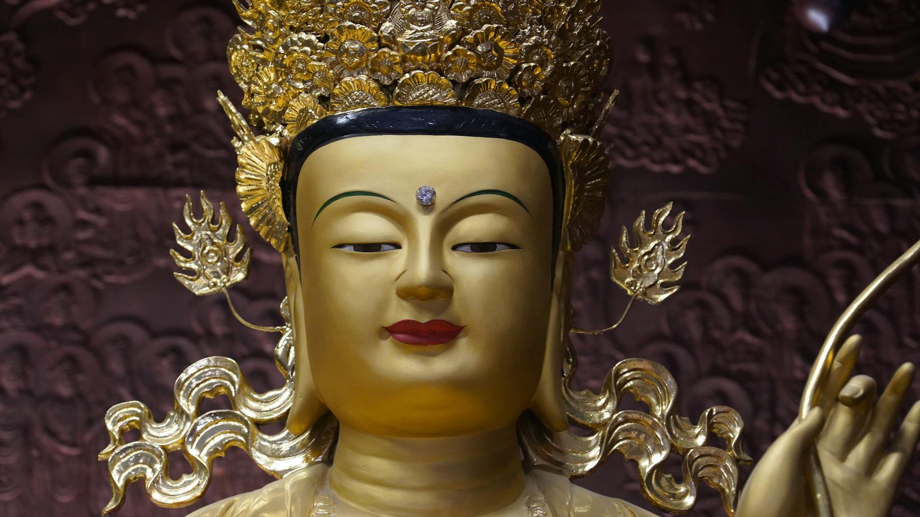 Close-up of an ornate golden Buddha statue in a Seoul temple, showcasing intricate detail.