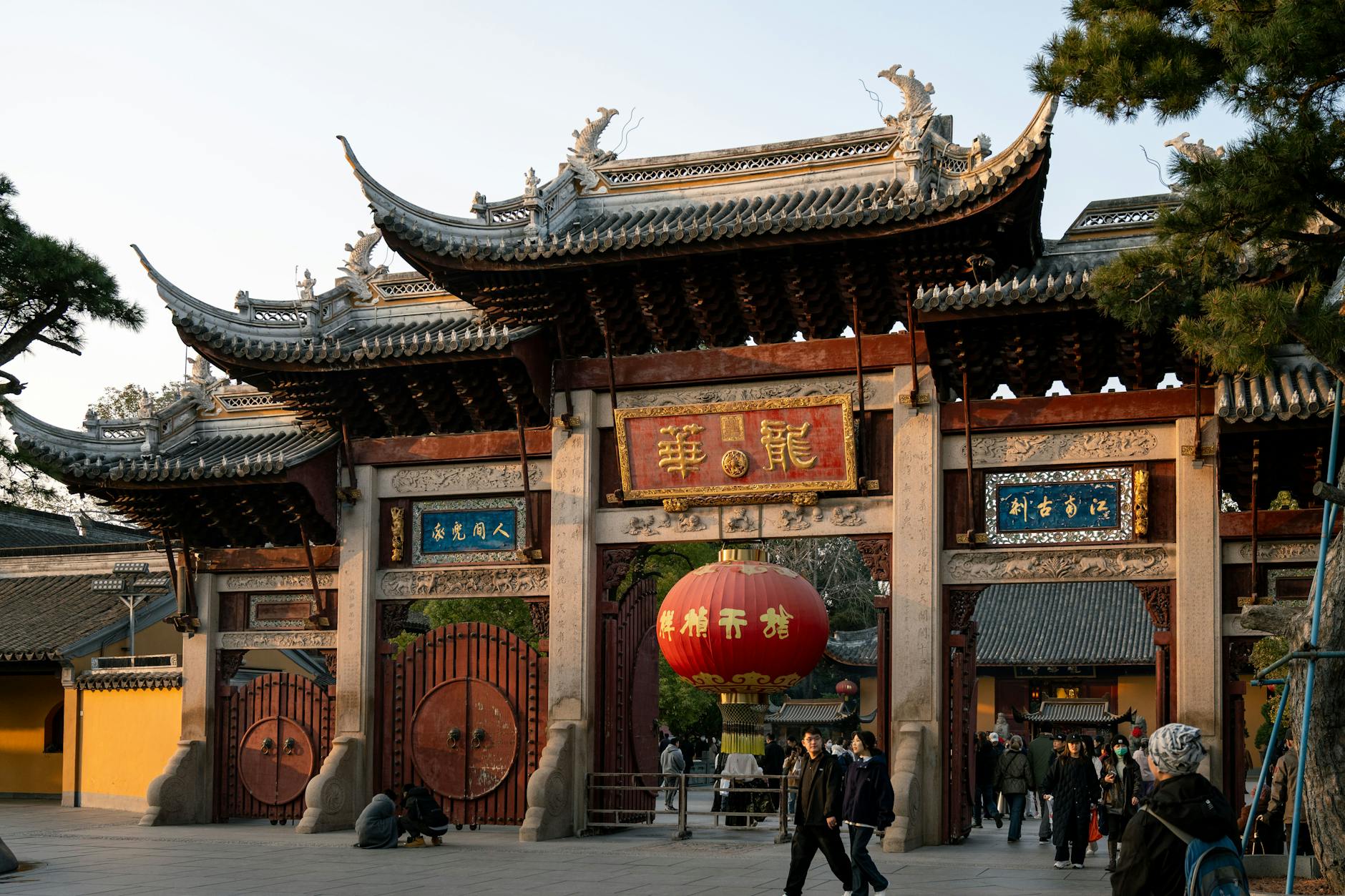 Beautiful traditional Chinese temple gate in Shanghai, captured during sunset, highlighting cultural architecture.