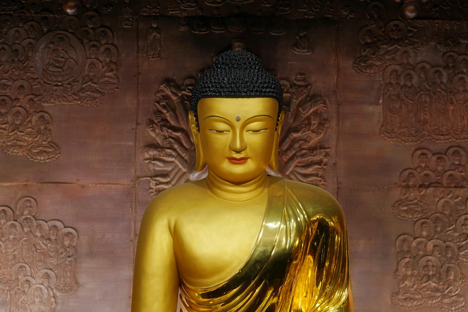 A serene golden Buddha statue inside a Seoul temple, representing peace and spirituality.